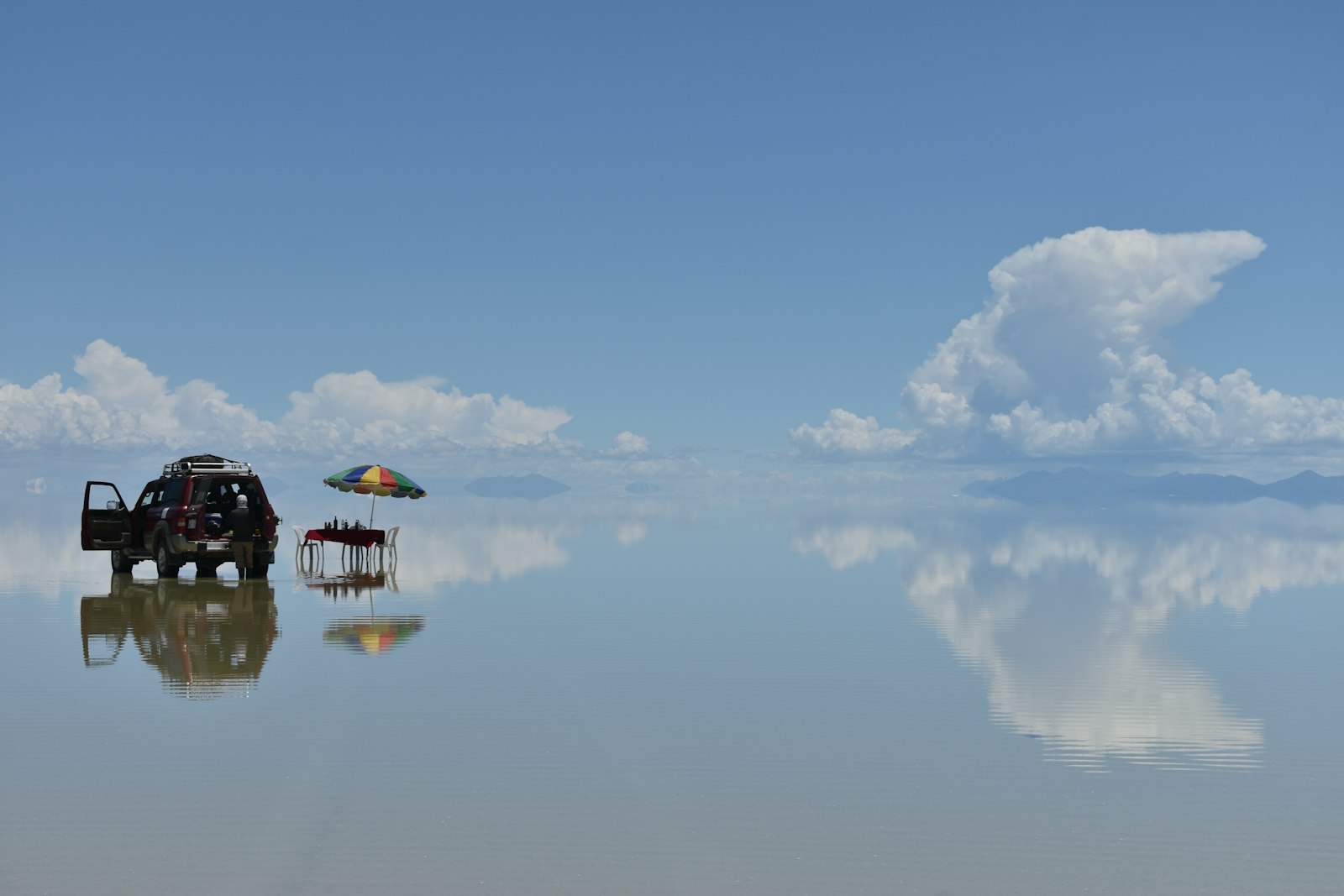 A vehicle reflected on the mirror of the Uyuni salt flat in Bolivia