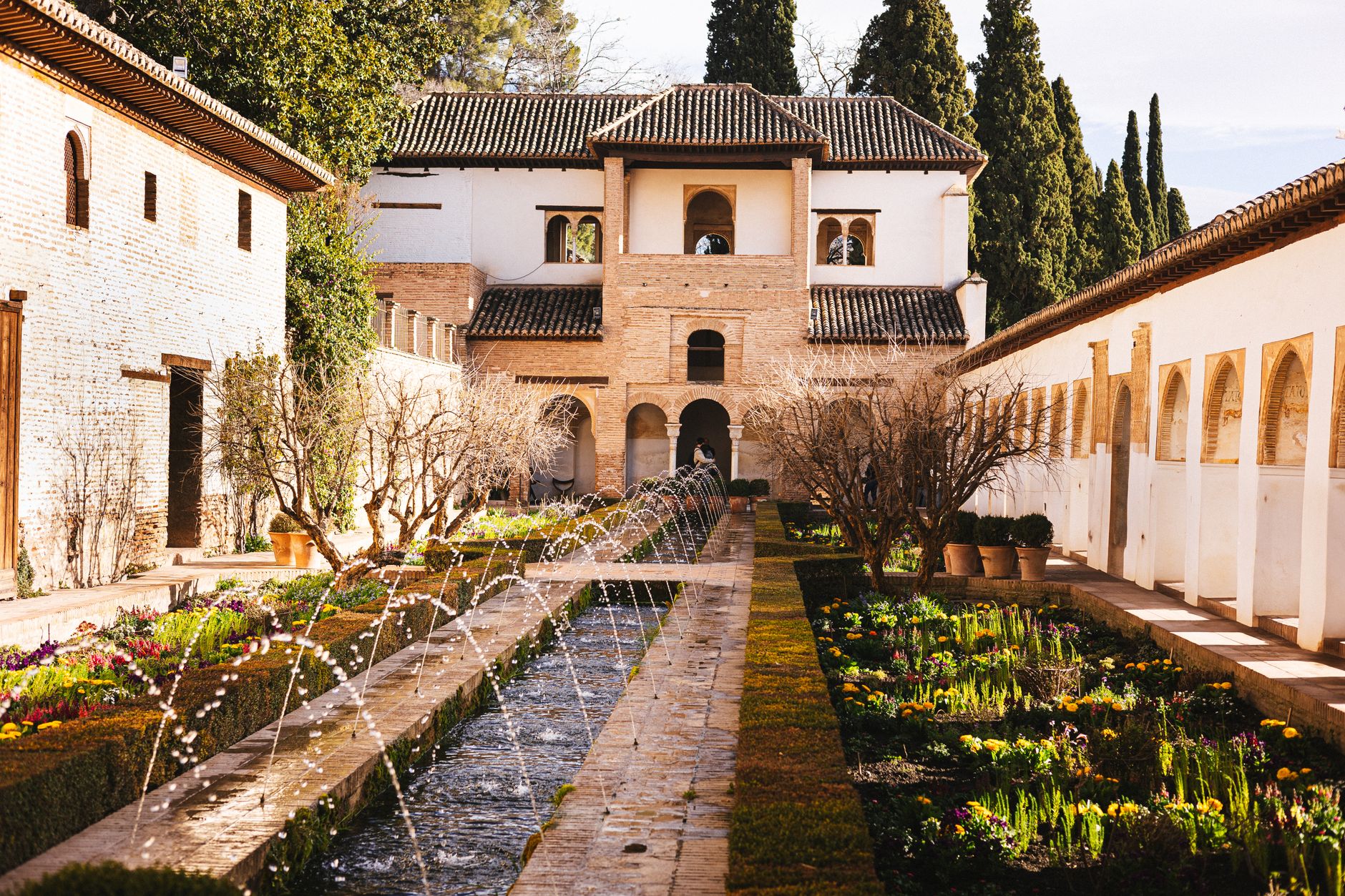 The Generalife gardens of the Alhambra, a long water channel lined with arcing jets and flowerbeds