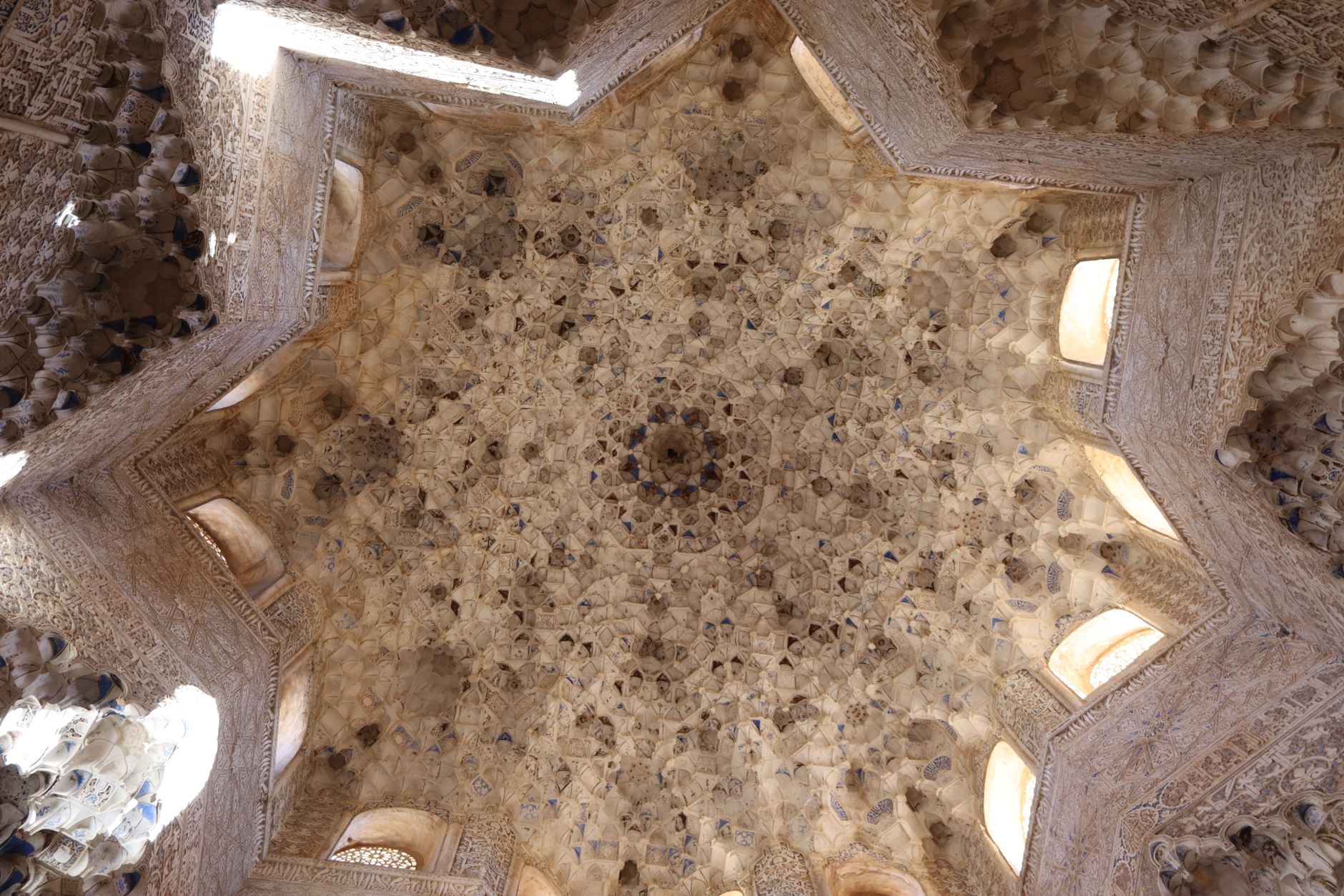 The honeycomb muqarnas dome of the Hall of the Two Sisters in the Alhambra, lit from windows around its base