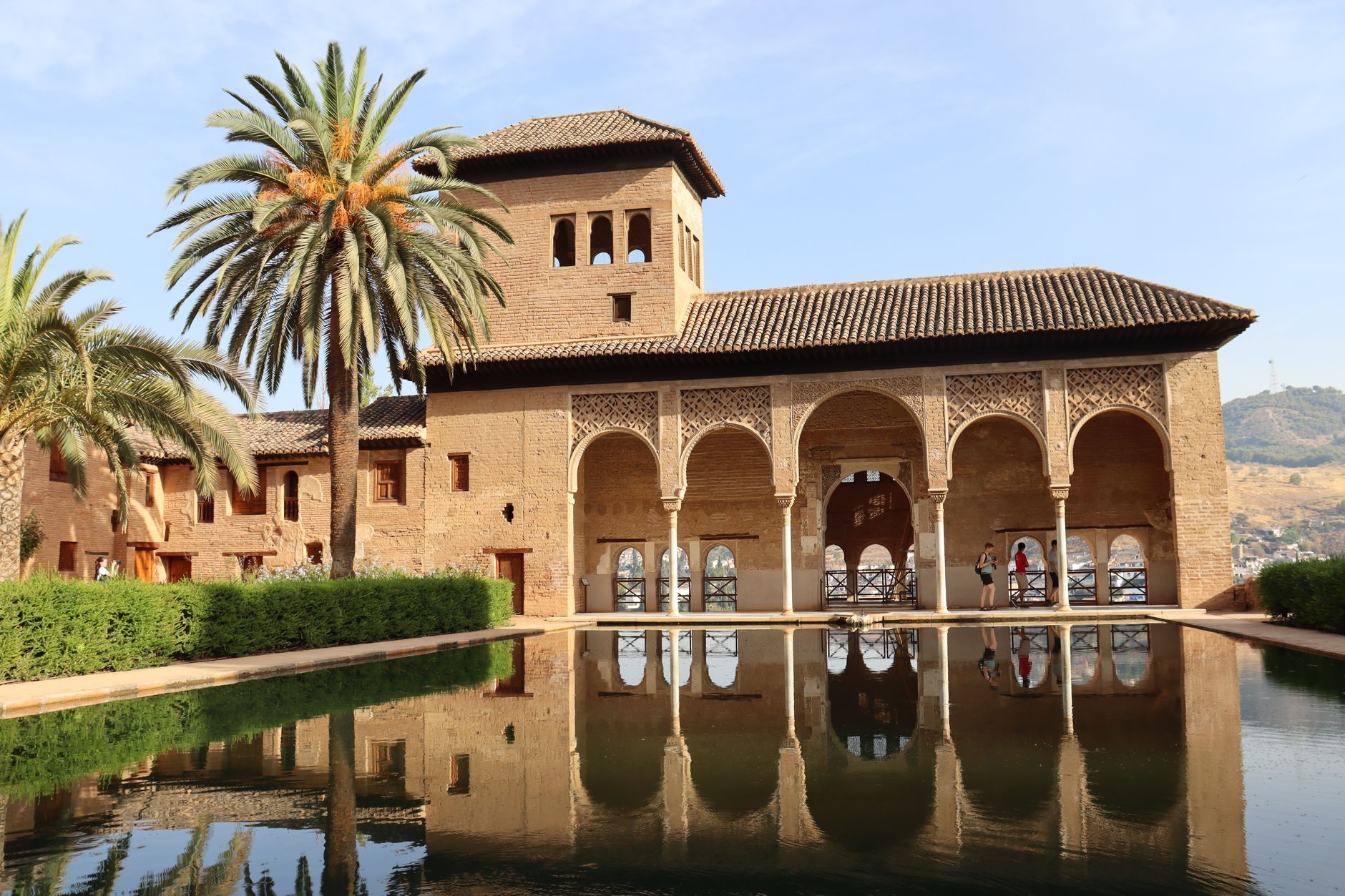 The Court of the Myrtles in the Alhambra, a long still reflecting pool mirroring the Comares tower
