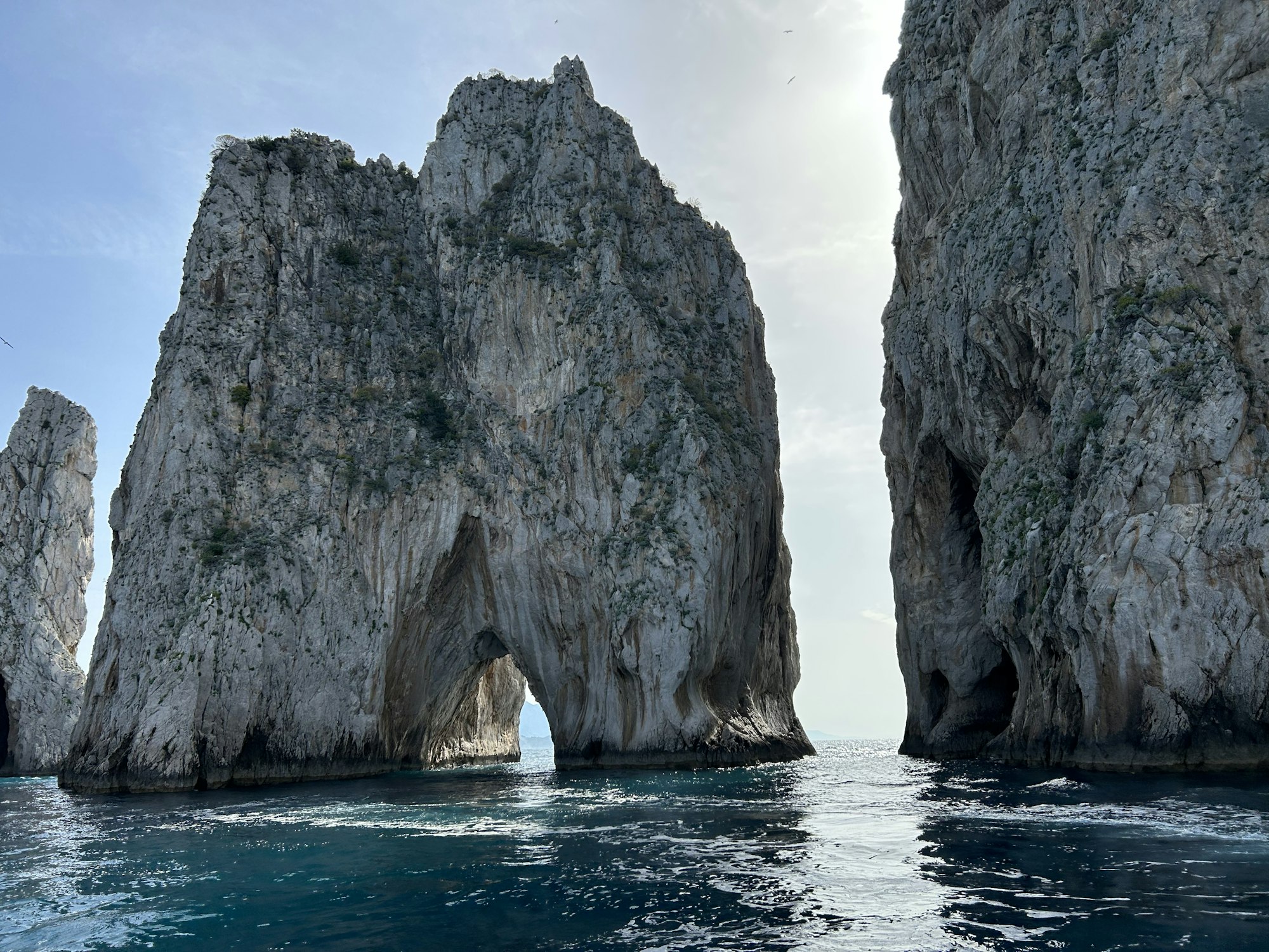 The Faraglioni rock stacks off Capri rising from blue water under a clear sky