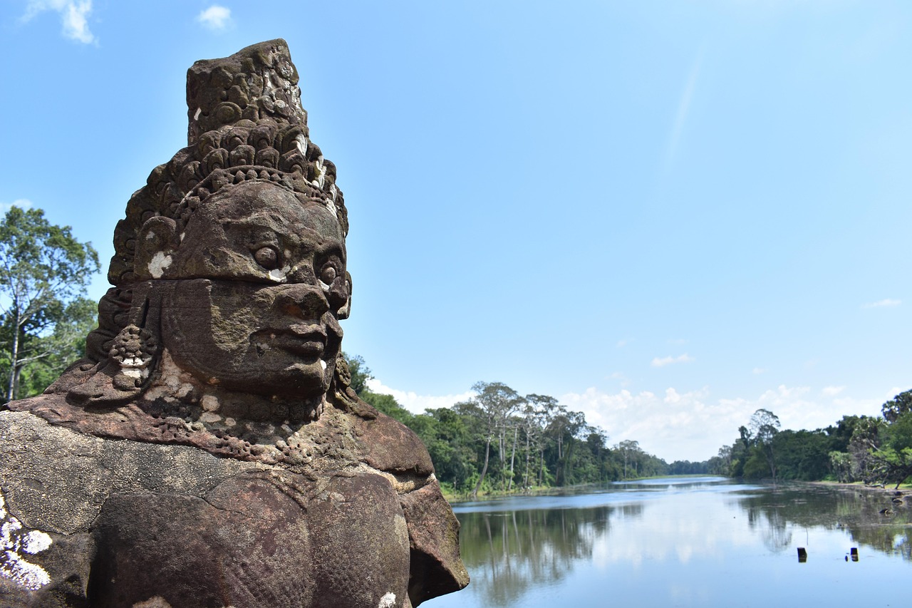 A giant stone guardian head on the causeway across the moat at Angkor Thom