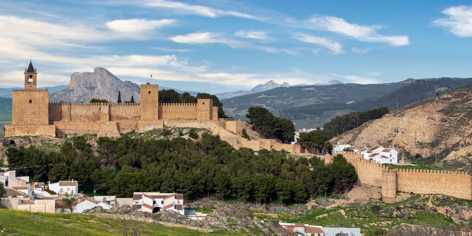 The Alcazaba of Antequera on its pine-covered hill, with the bell turret on the keep and the town walls running down to the right