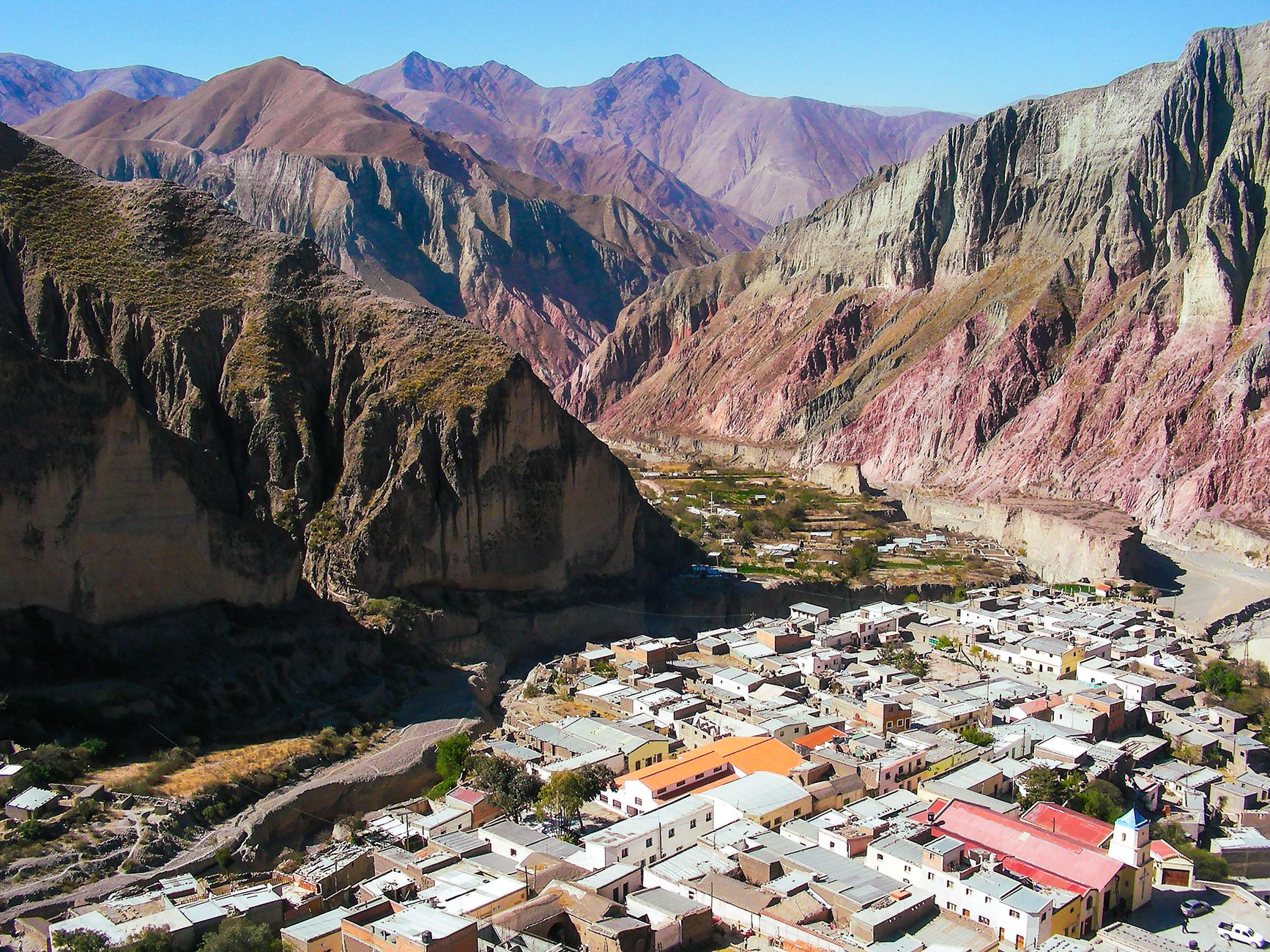 An adobe village below the coloured mountains of the Quebrada de Humahuaca