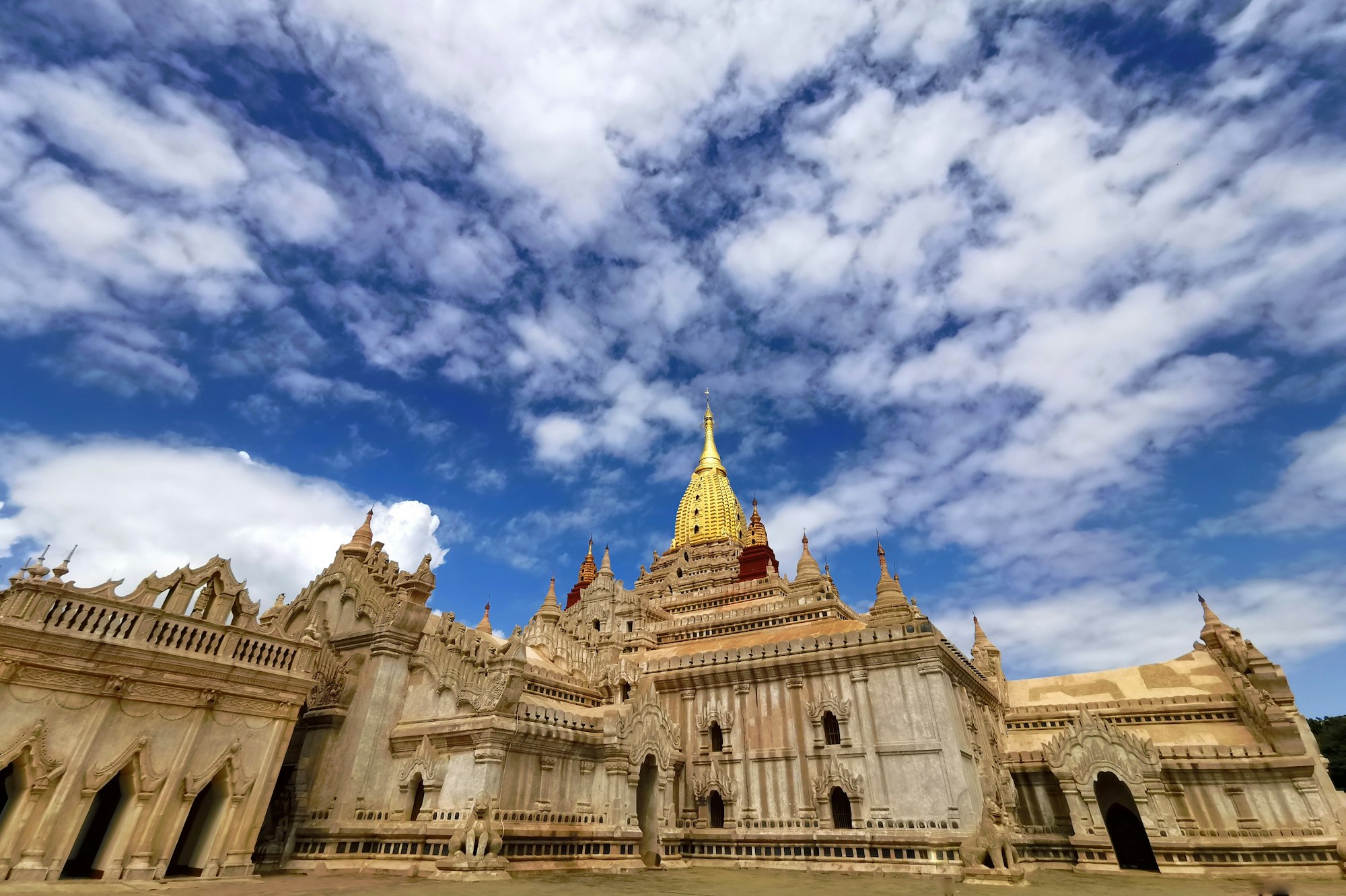 The white and gold spired Ananda Temple in Bagan under a blue sky