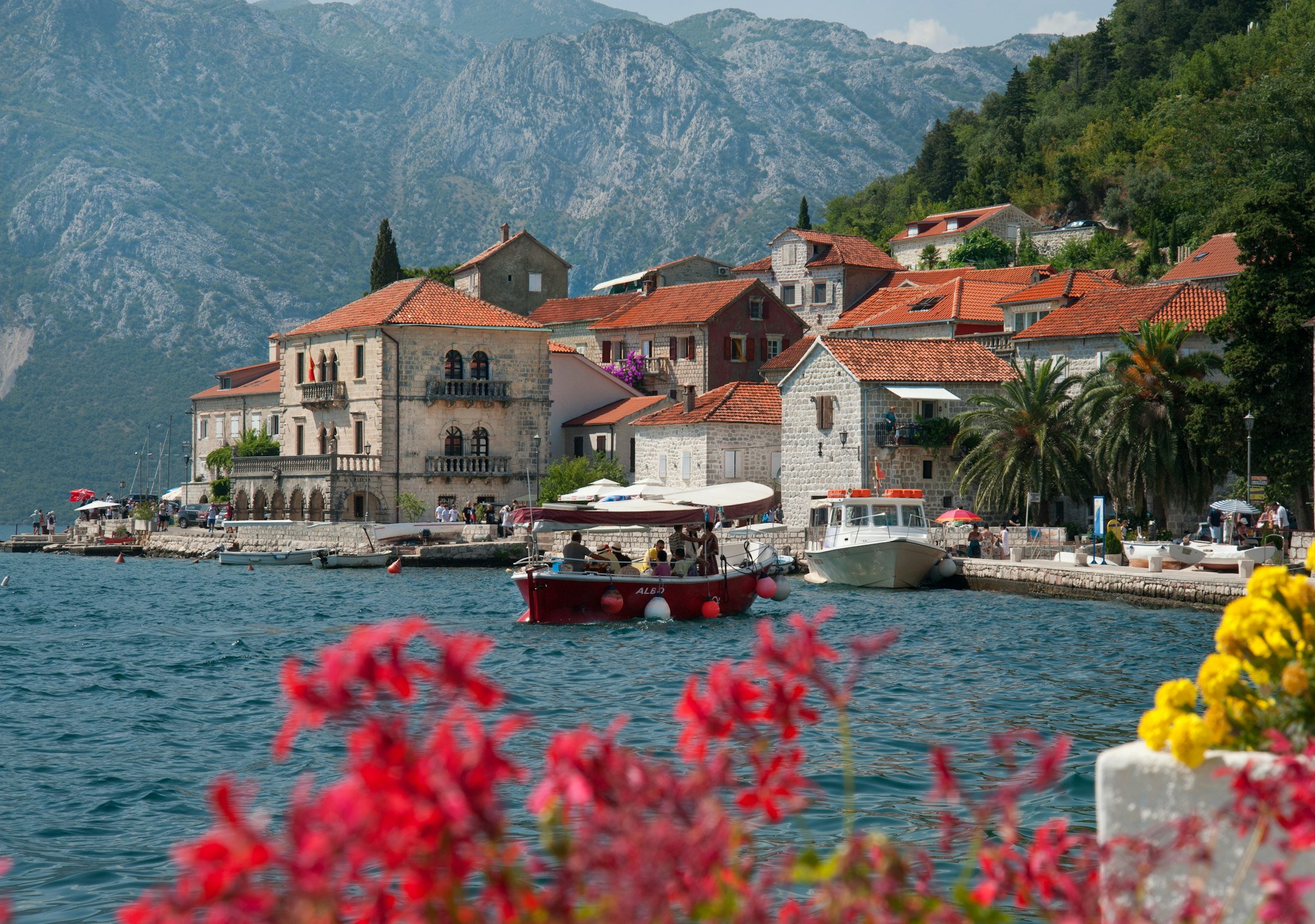The baroque waterfront of Perast on the Bay of Kotor, stone palazzos and a boat below the mountains
