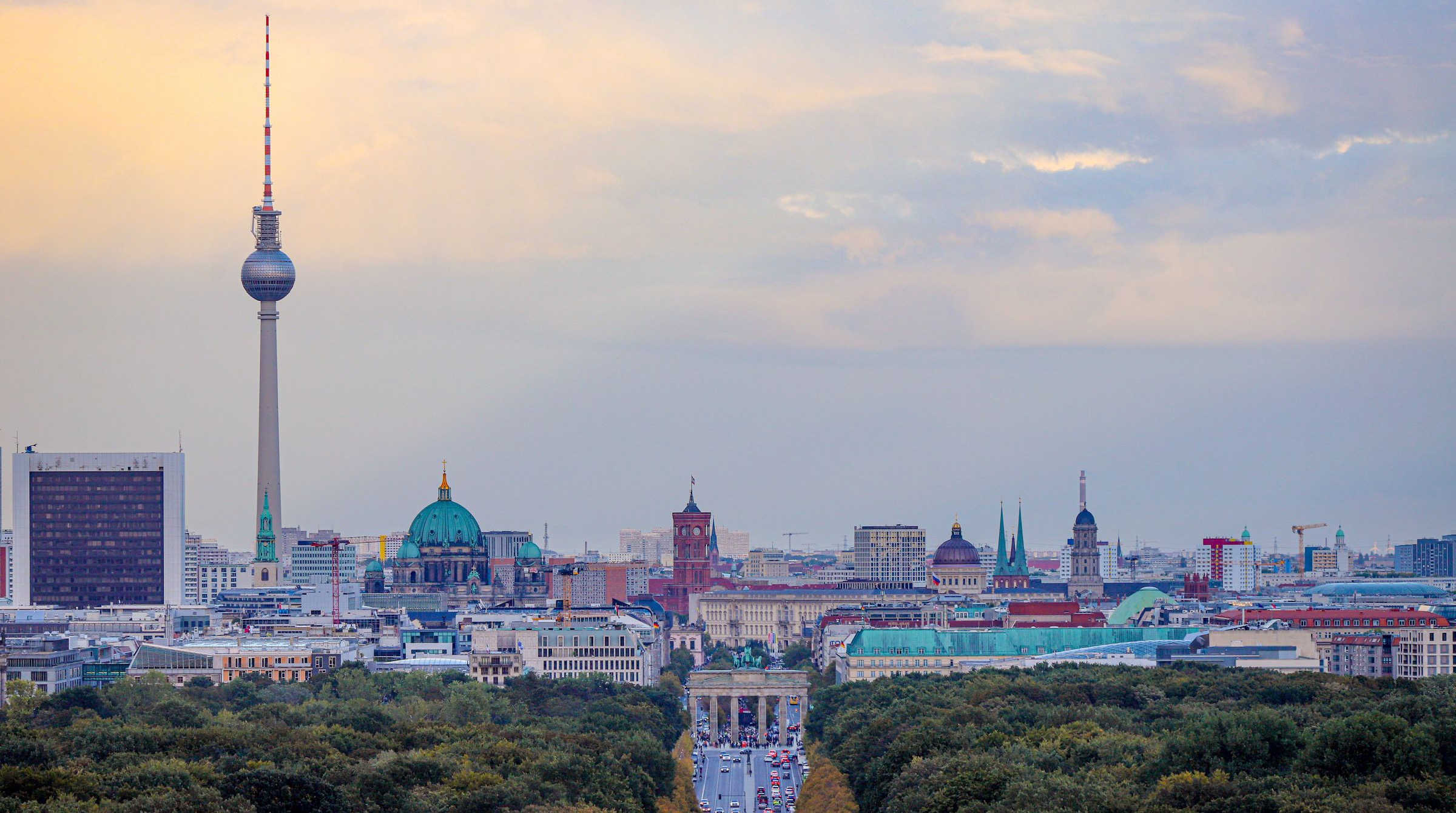 Berlin from the Victory Column at dusk, the Brandenburg Gate at the end of the Tiergarten avenue with the Berlin Cathedral dome and the TV Tower beyond