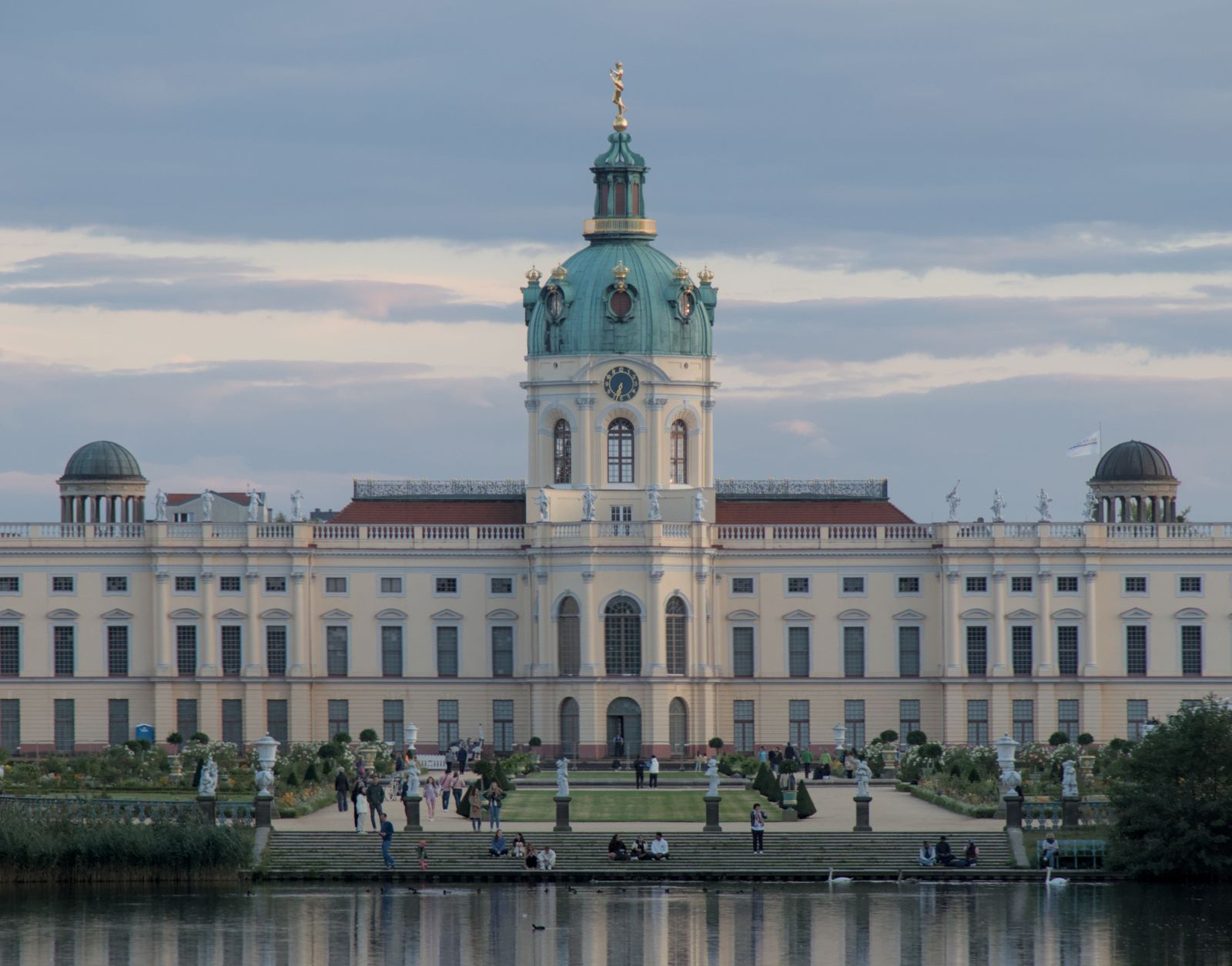 Charlottenburg Palace across the pond in its garden at dusk