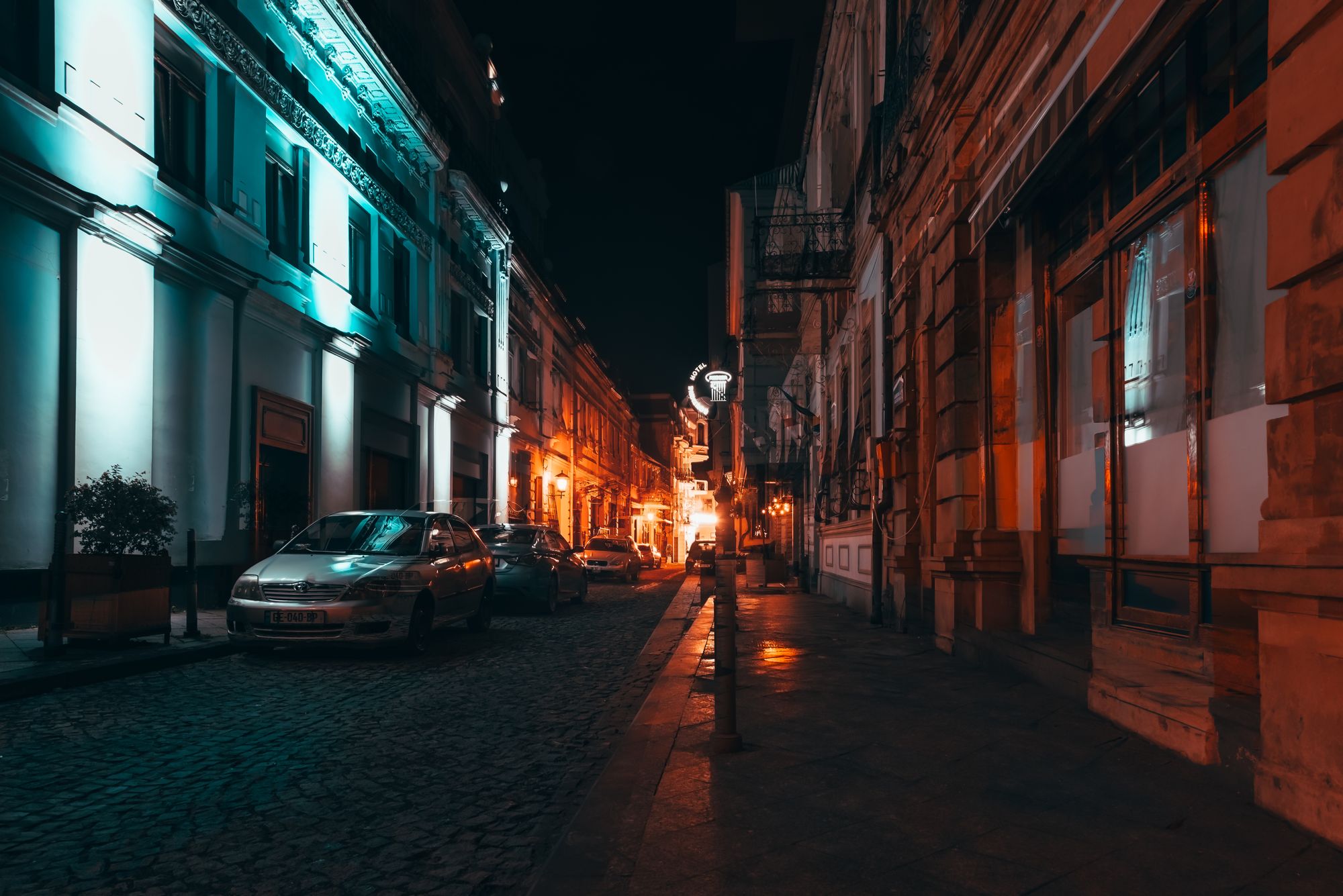 A cobbled street of the Bucharest old town lit at night