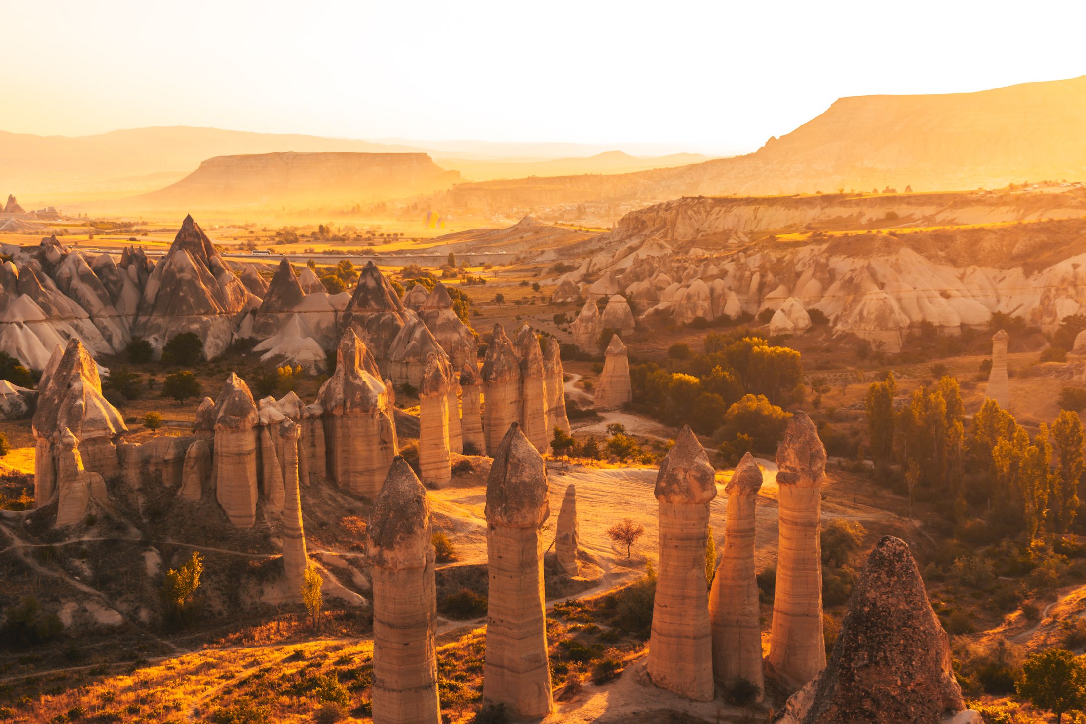 The fairy-chimney valley of Cappadocia glowing gold at sunset