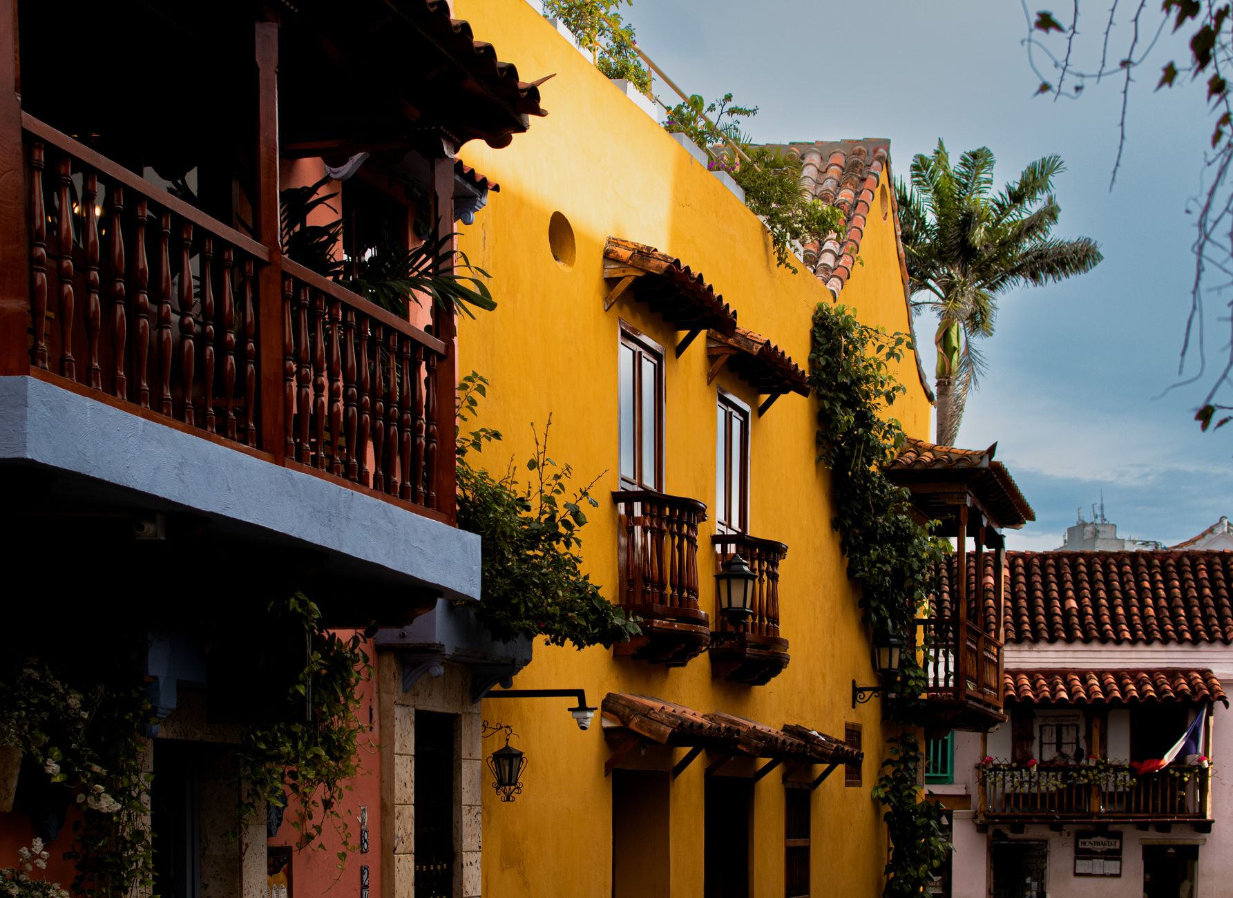 Balconied colonial houses in bright colours along a street in Cartagena's walled city