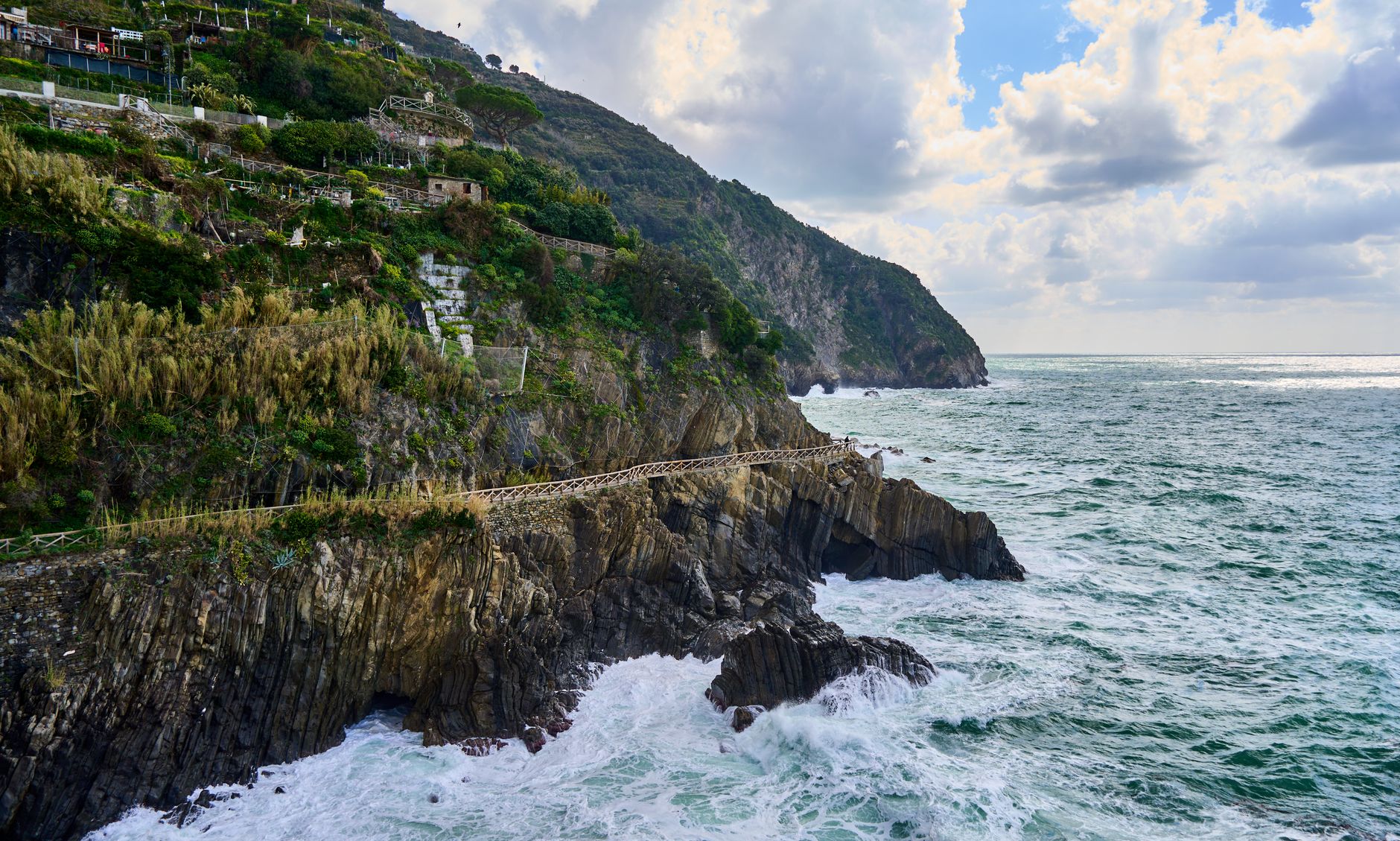The coastal Blue Trail cut into the cliff of the Cinque Terre, the sea breaking on rocks far below