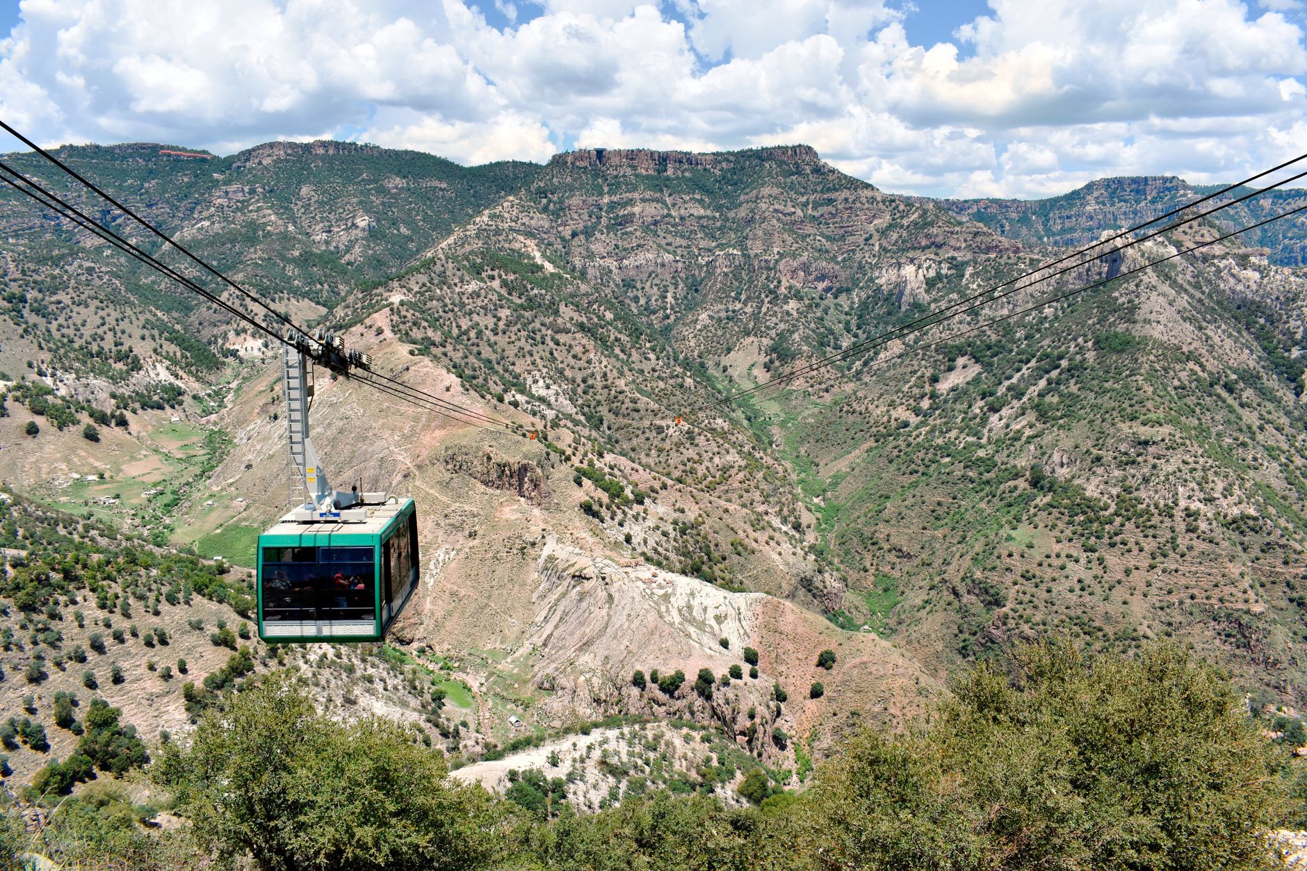 A cable car gliding across the Copper Canyon at Divisadero