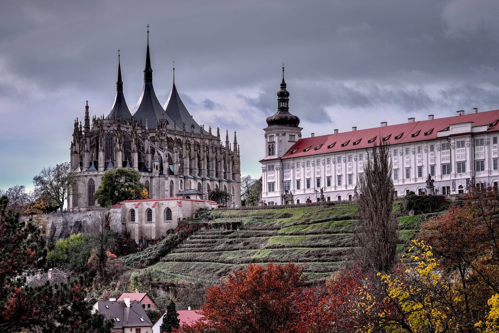 The Gothic spires of St Barbara’s Church beside the long front of the Jesuit College, above terraced gardens in Kutná Hora
