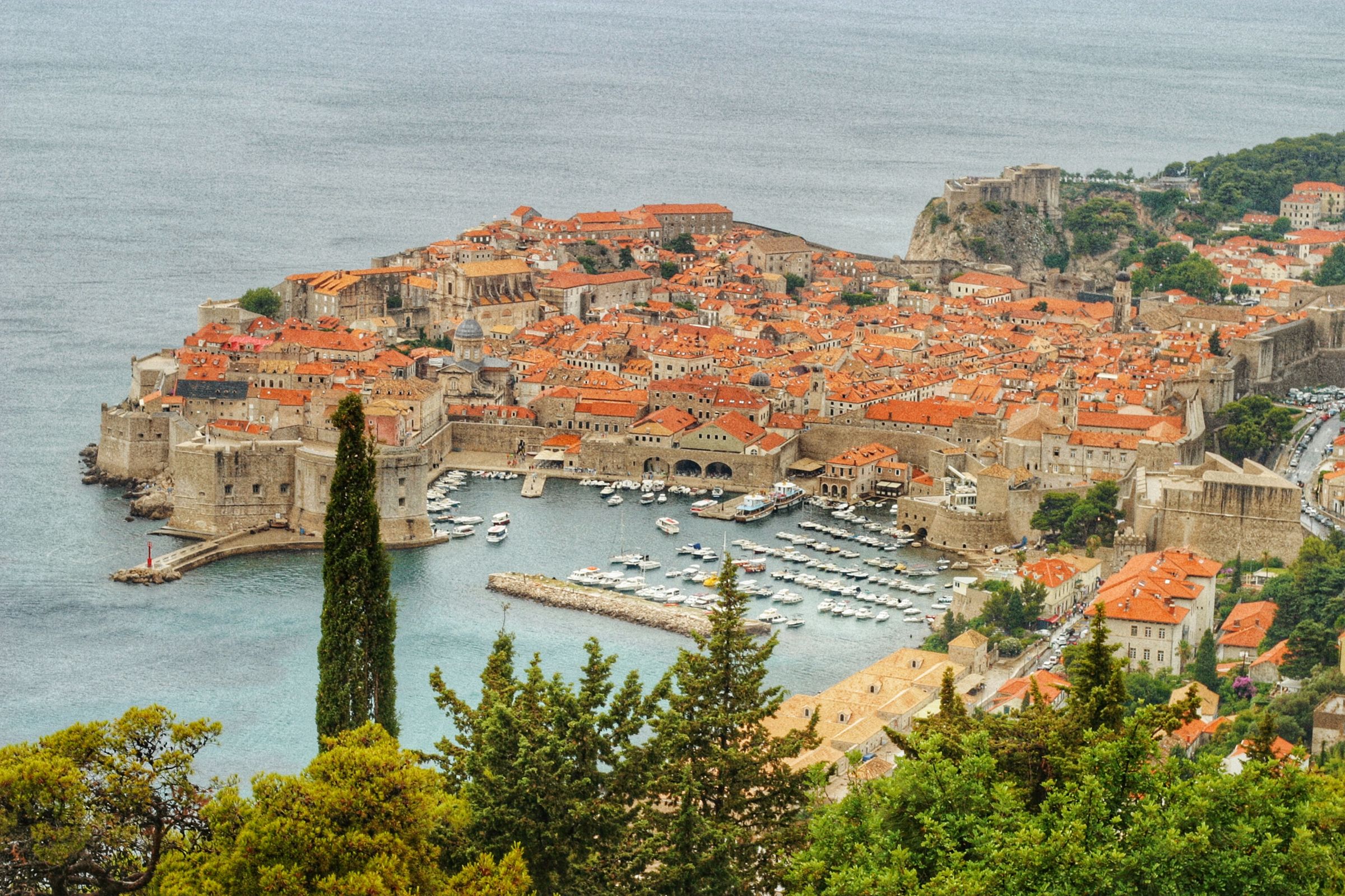 Dubrovnik's walled old town on its promontory, the harbour below the ramparts and the Adriatic beyond