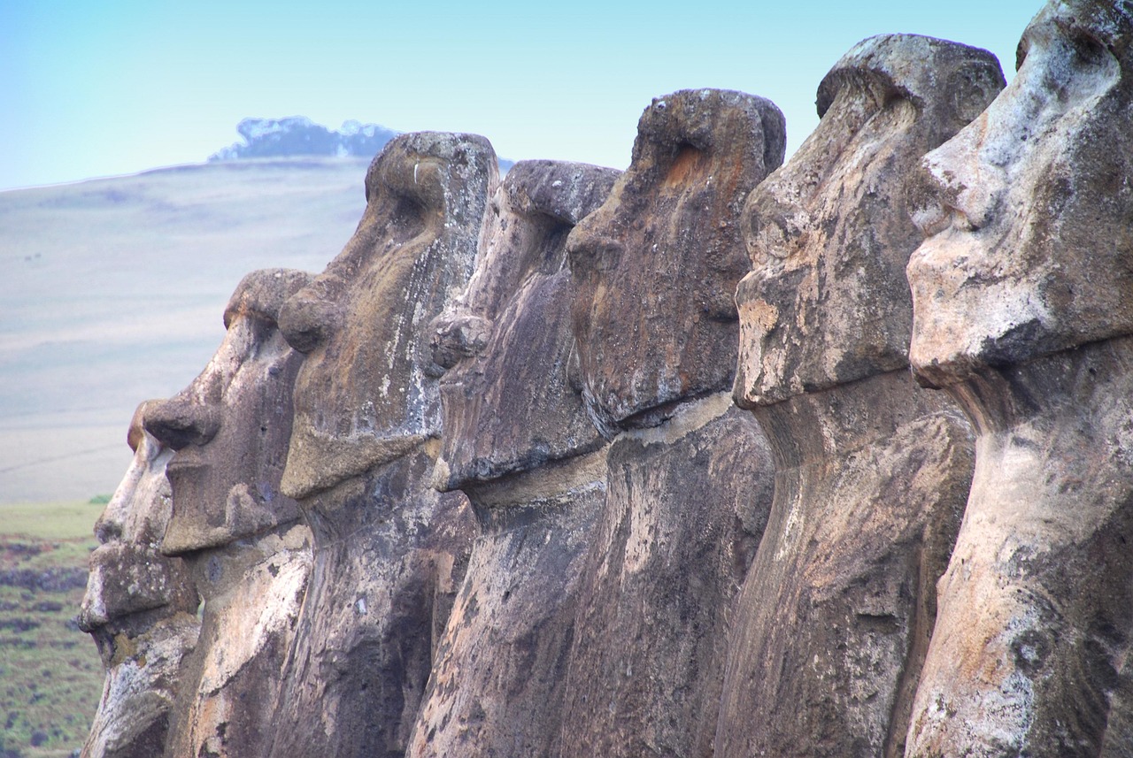 A close row of moai seen from the side, brows and noses repeating in sequence