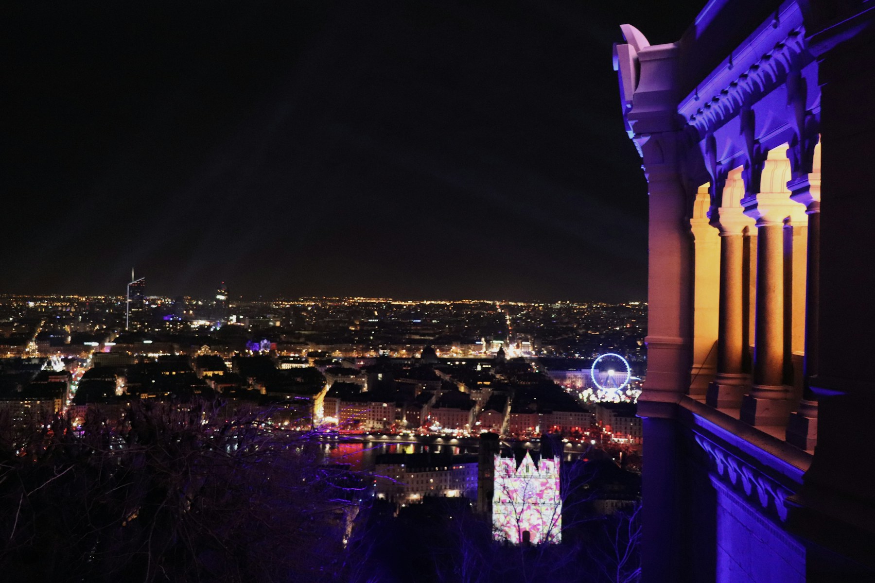 Lyon lit up at night seen from beside the basilica of Fourvière during the Fête des Lumières