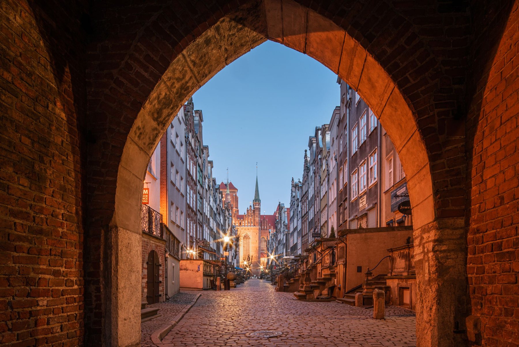 A cobbled alley in Gdańsk old town at dusk