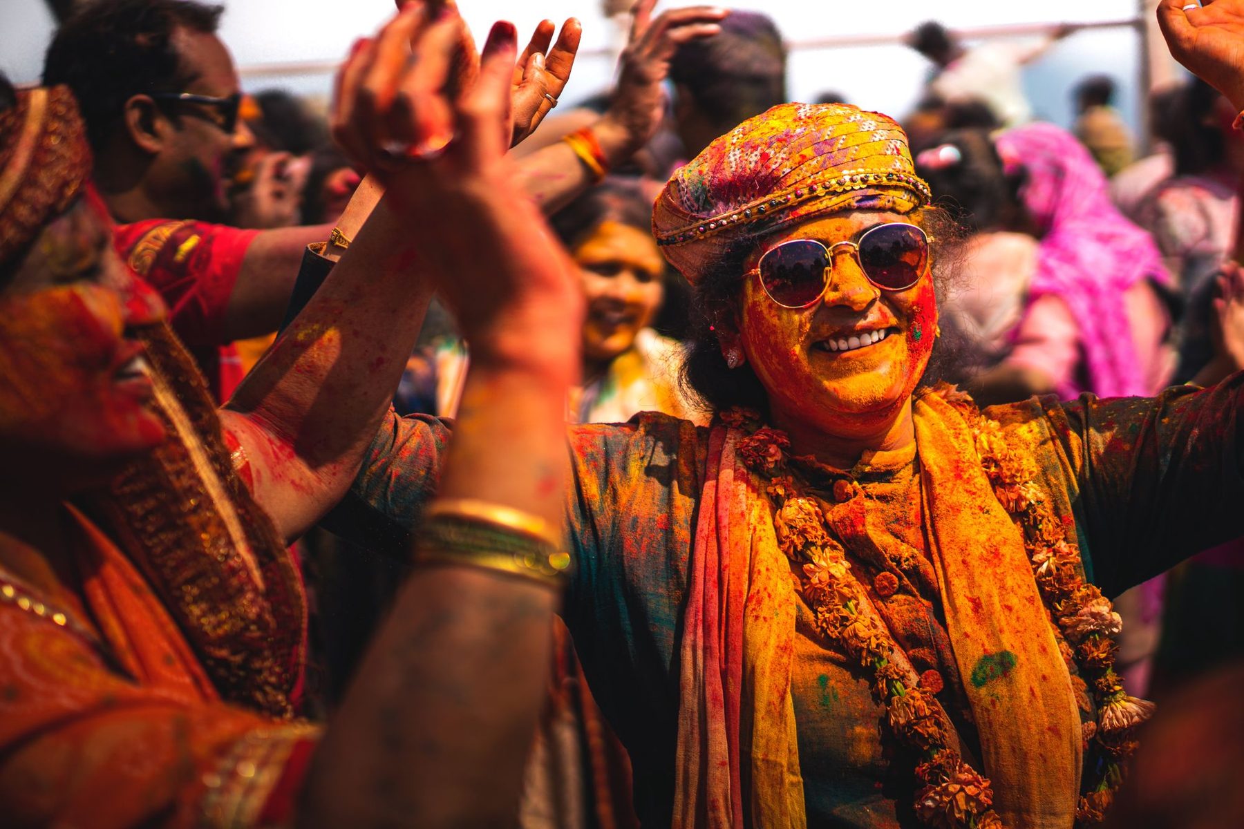 Faces smeared with colour in the Barsana crowd during Lathmar Holi