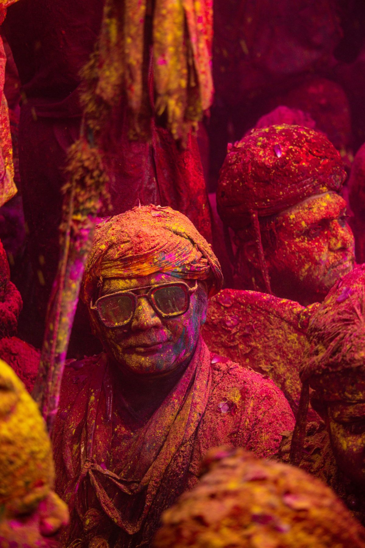 A man in Vrindavan covered head to foot in red, yellow and green powder during Holi