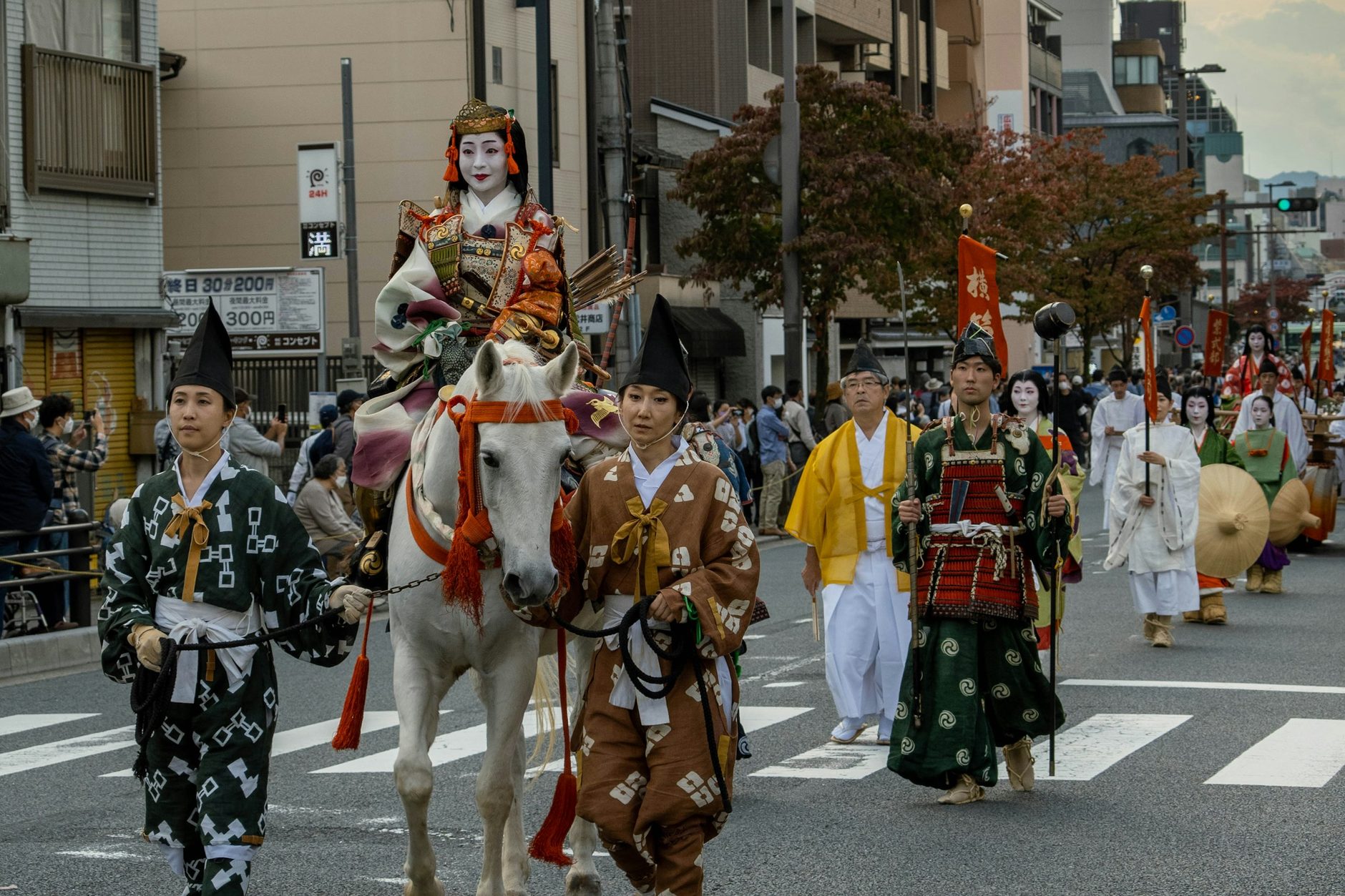 Costumed riders in armour and marchers in the Jidai Matsuri procession on a Kyoto street