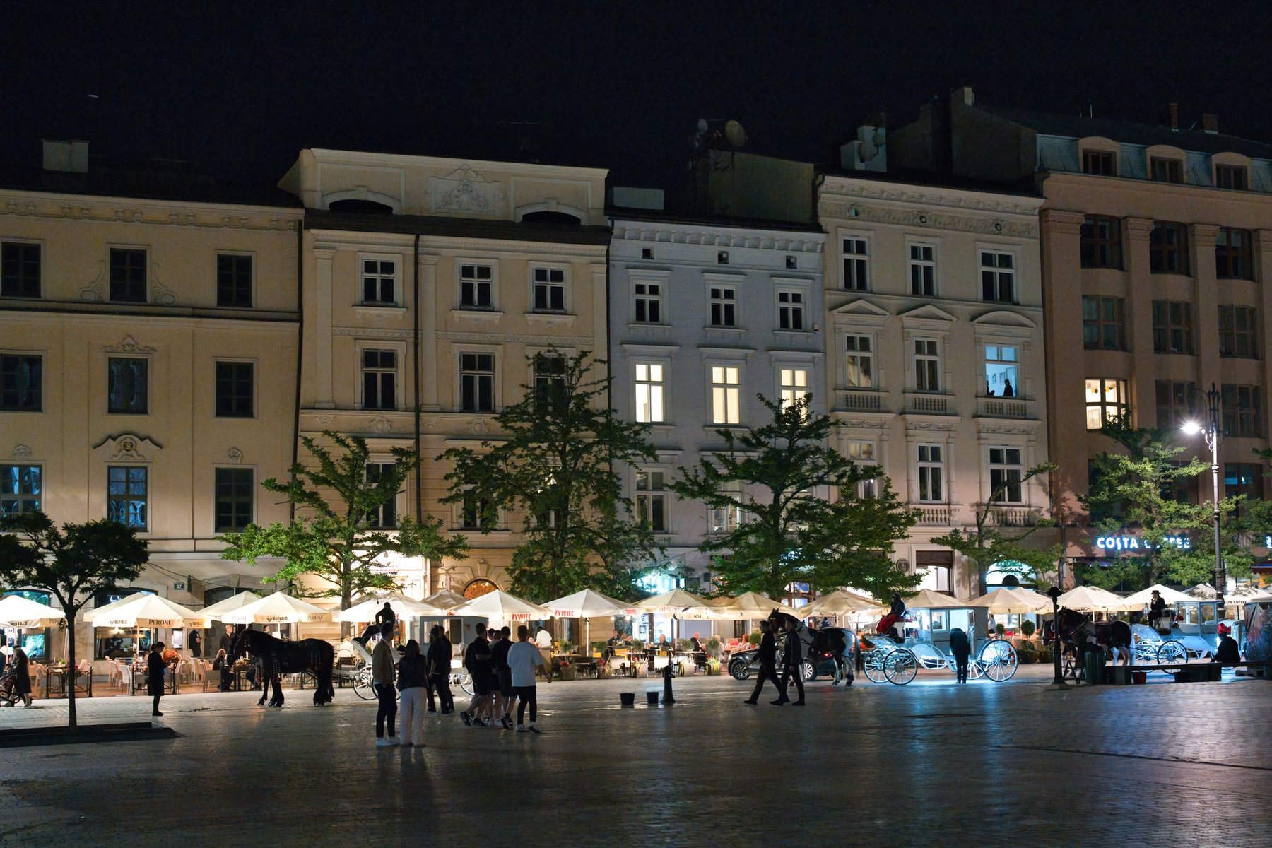 Kraków's main square at night, with the market lights along the buildings