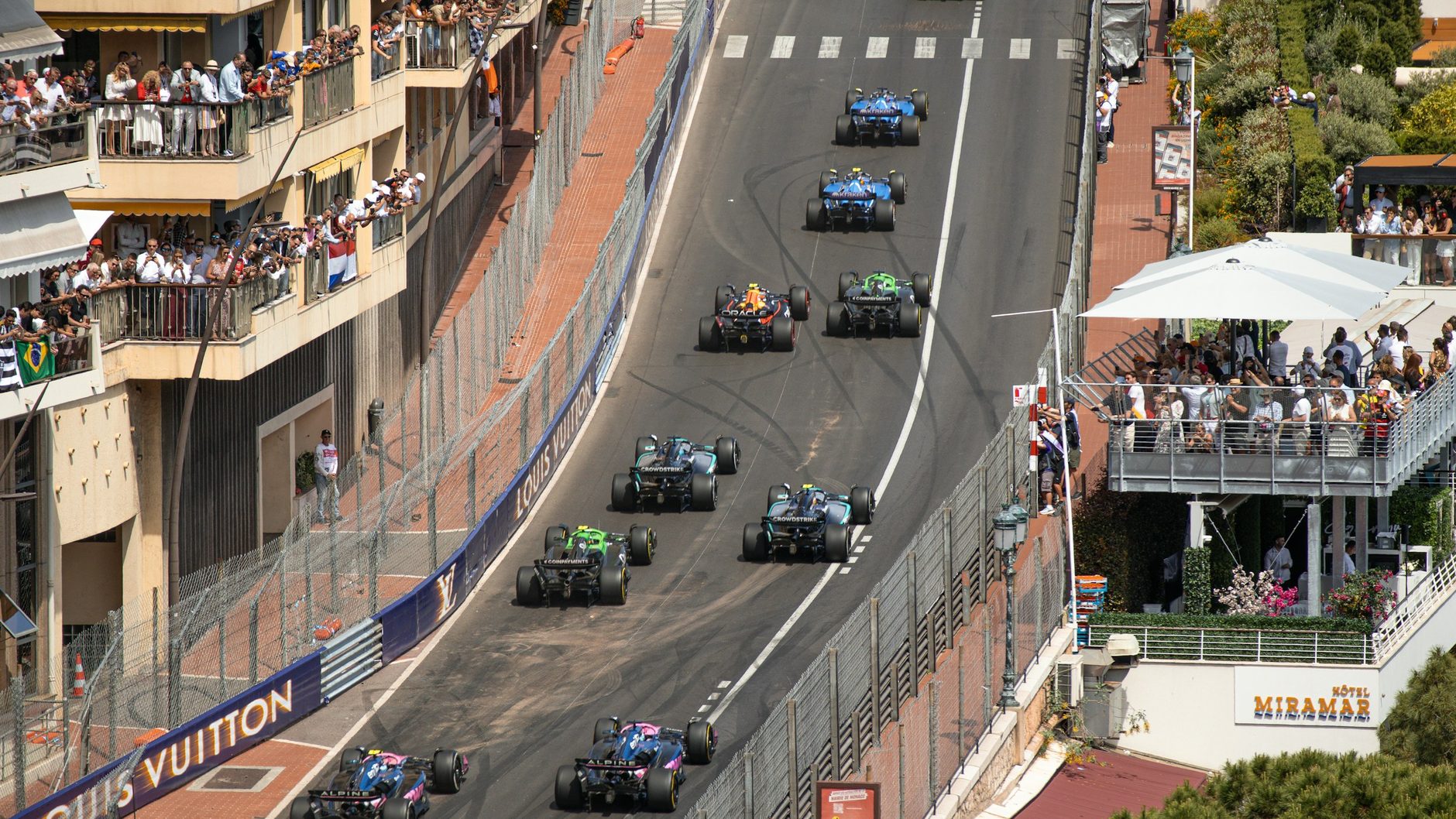 The start of the Monaco Grand Prix: a train of Formula 1 cars climbing past the terraces above Sainte-Dévote