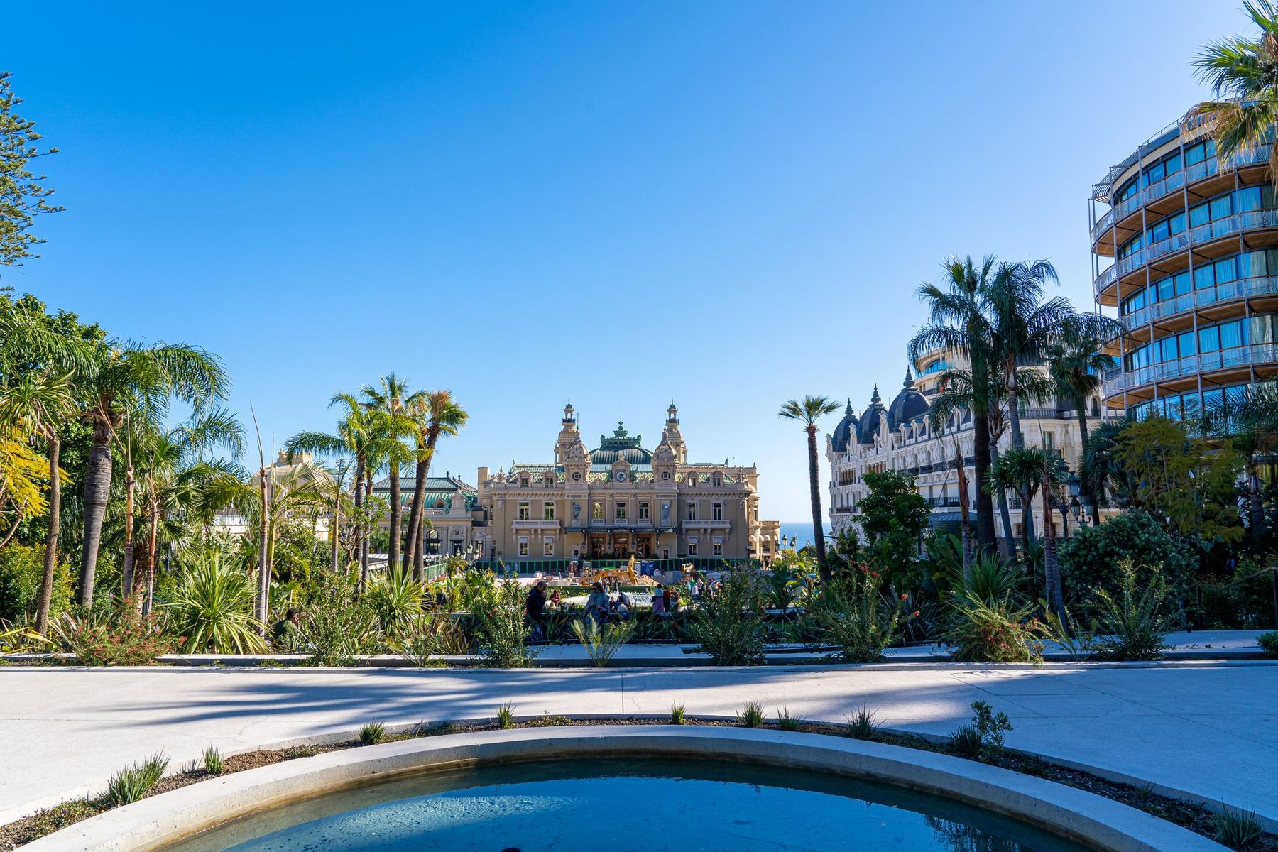 The Monte-Carlo Casino and the Hôtel de Paris under palm trees and a blue sky
