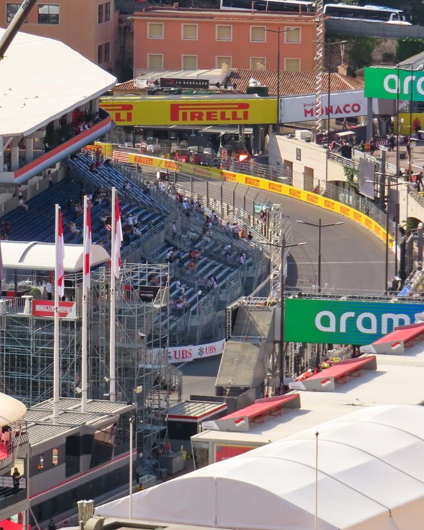 The Monaco Grand Prix circuit from above, with grandstands along the harbour, the pit buildings and the hill of Monaco-Ville behind