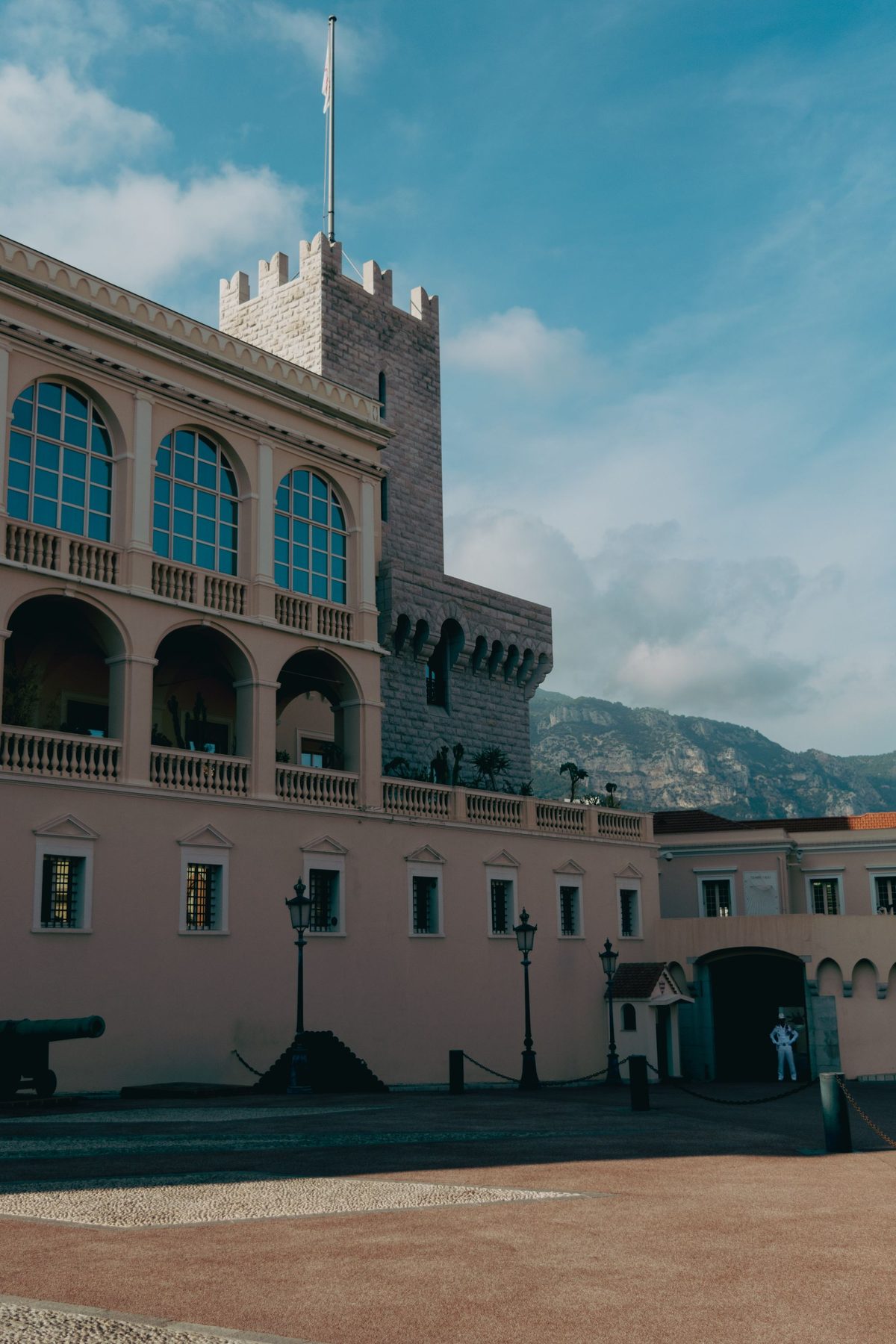 The Prince's Palace of Monaco in sunlight, pale stone and a tower above the Rocher