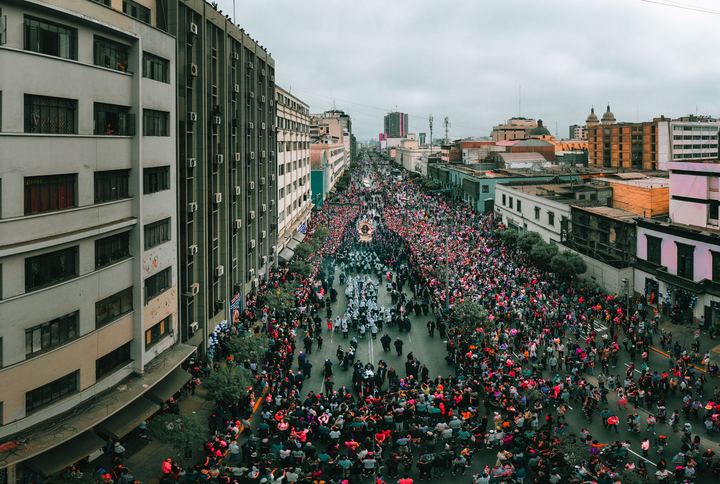 The Señor de los Milagros procession filling an avenue in central Lima, seen from above