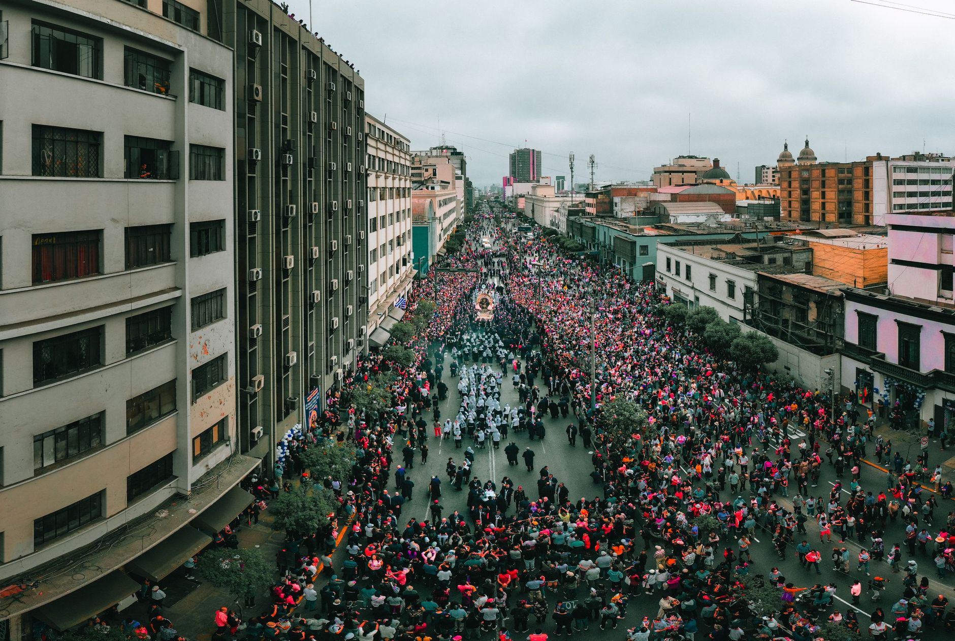 The Señor de los Milagros procession filling an avenue in central Lima, seen from above
