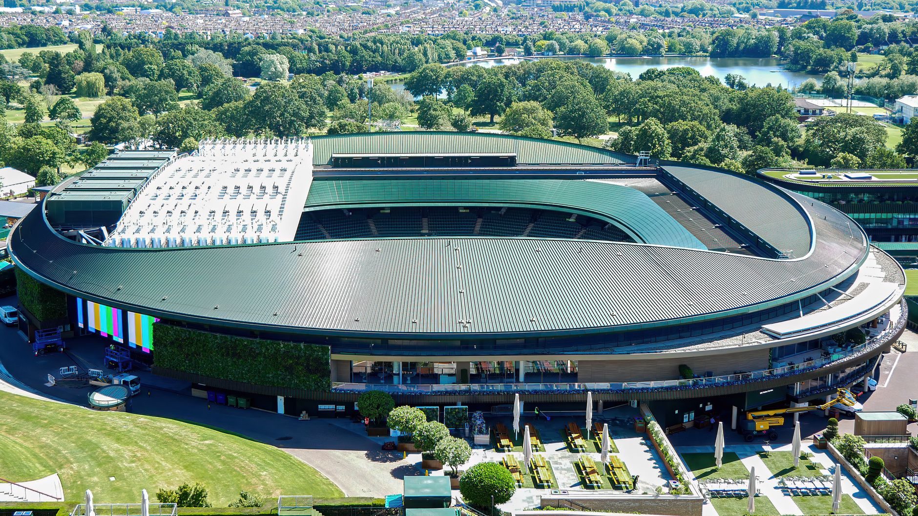 A show court at the All England Club from the air, with the lake in Wimbledon Park behind it