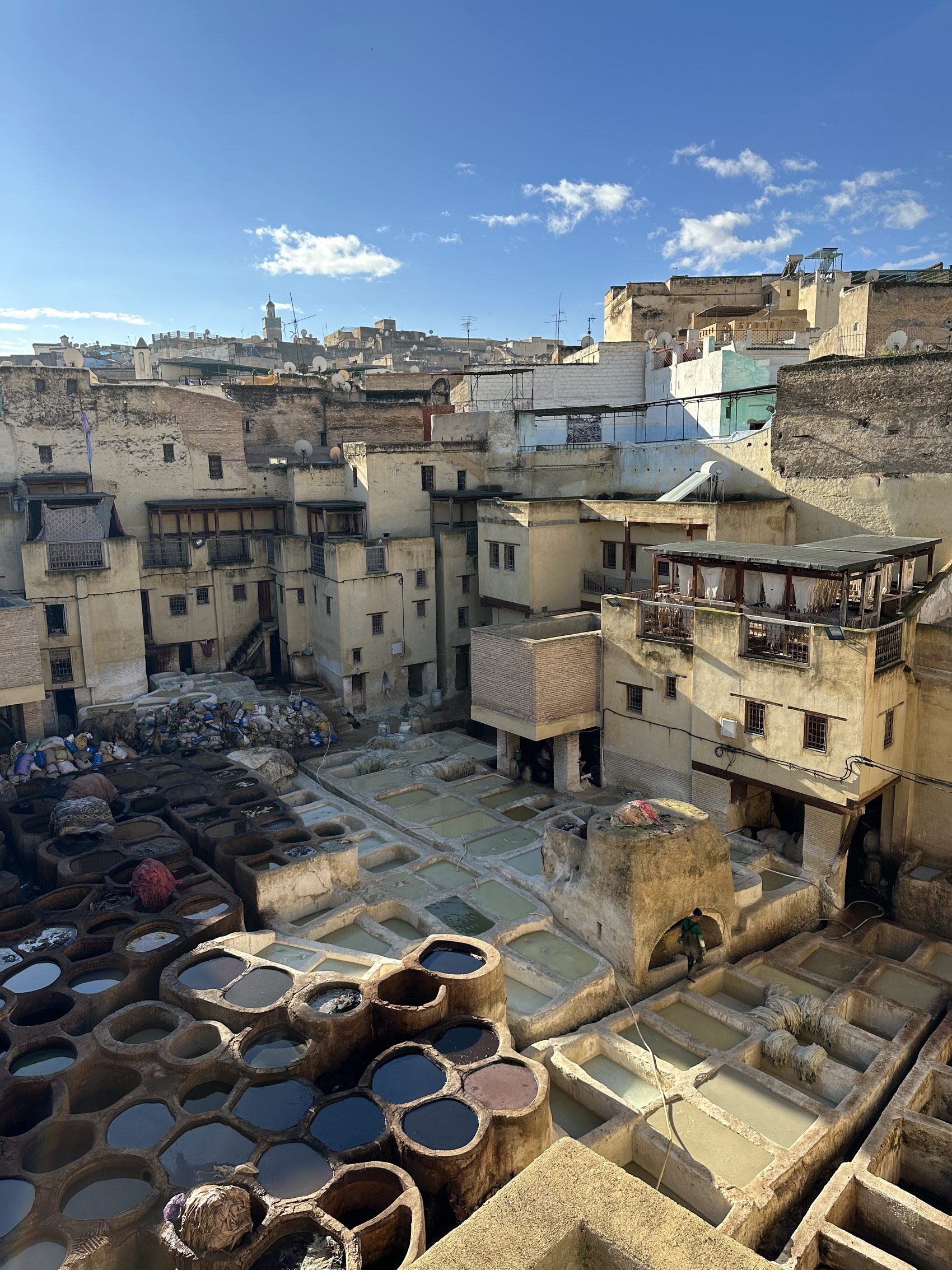 The stone dye vats of the Chouara tannery in Fez seen from a leather-shop terrace above