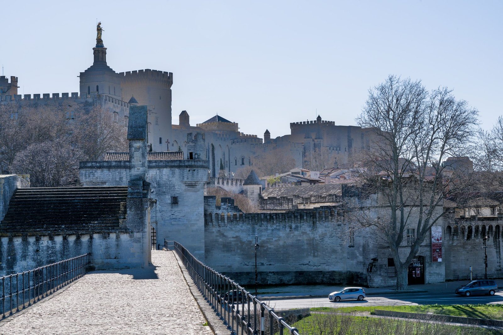 The Pont Saint-Bénézet running out over the Rhône at Avignon, with the city walls and the towers of the Palais des Papes behind