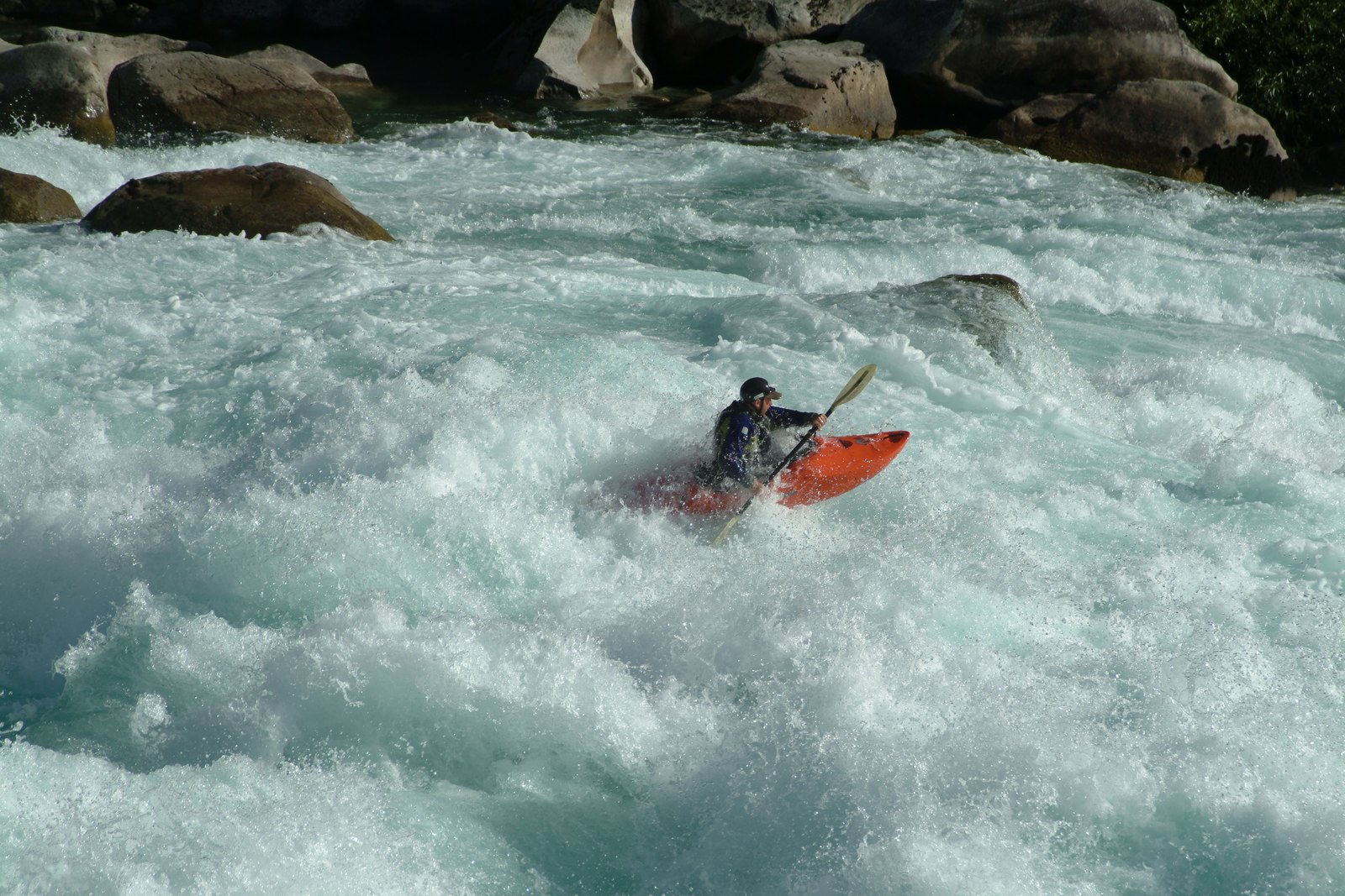 A kayaker in the huge turquoise whitewater of the Terminator rapid on the Futaleufu river