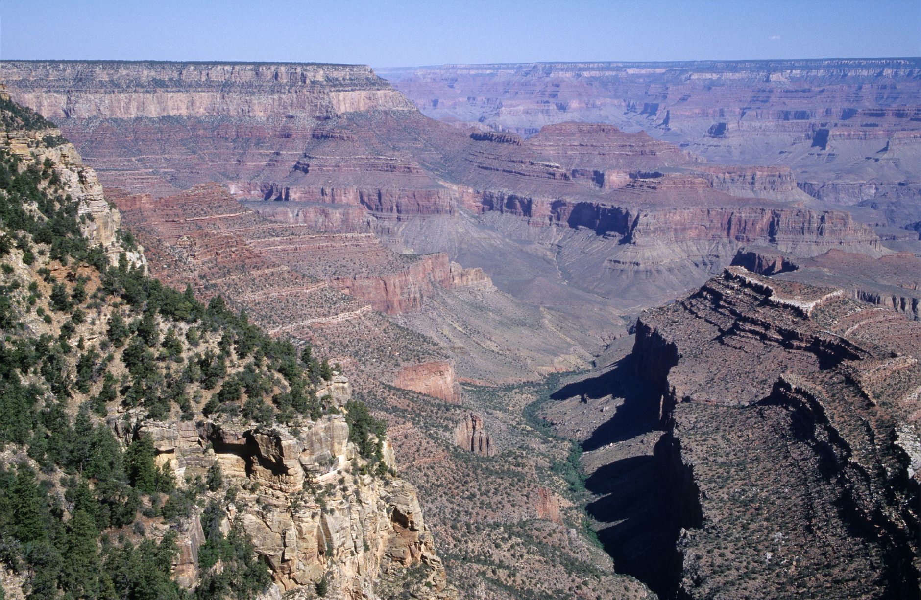Wide view over stacked ridges and side canyons of the Grand Canyon from an overlook on the South Rim