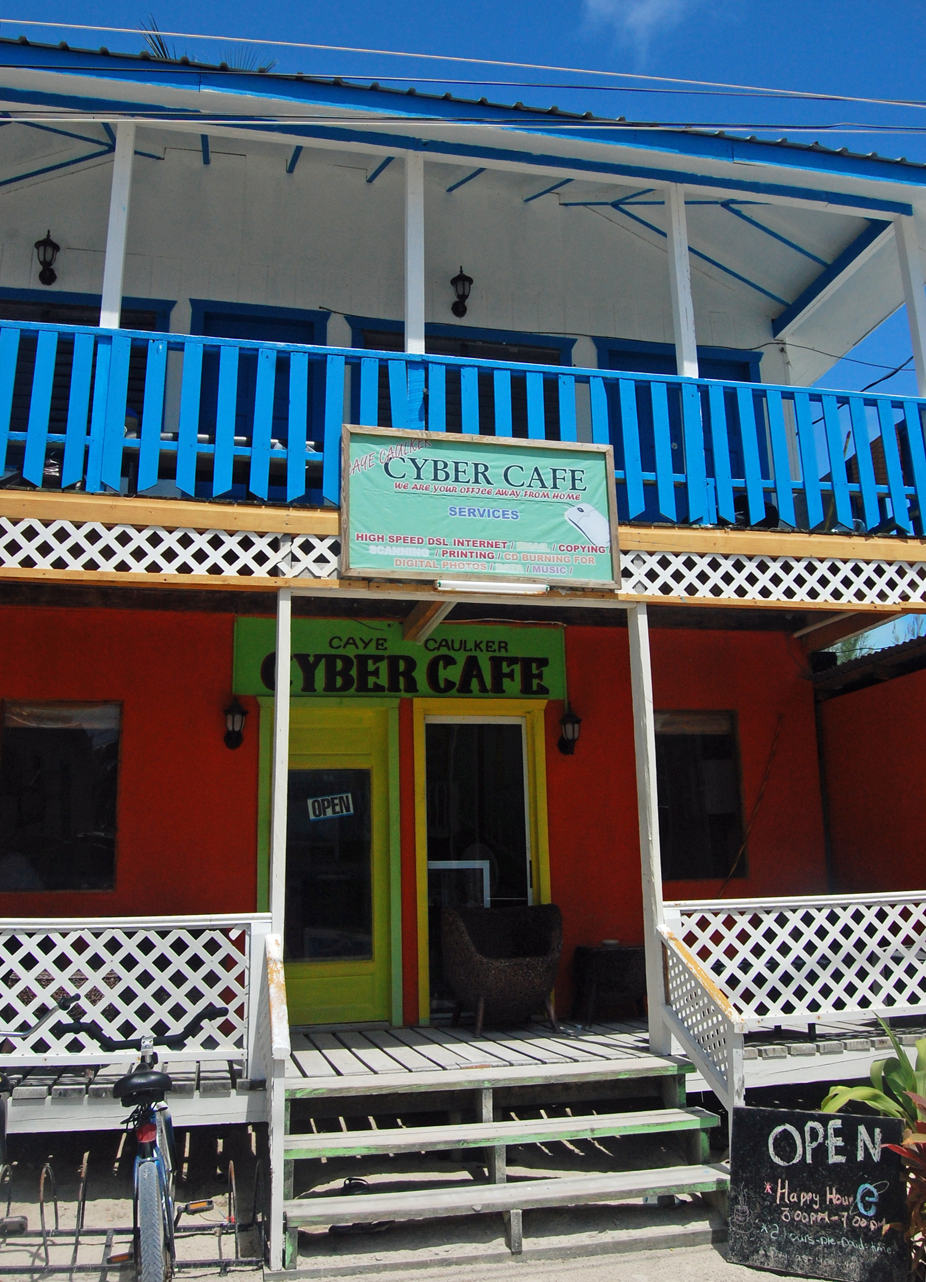 The painted timber front of a two-storey cafe on Caye Caulker, Belize