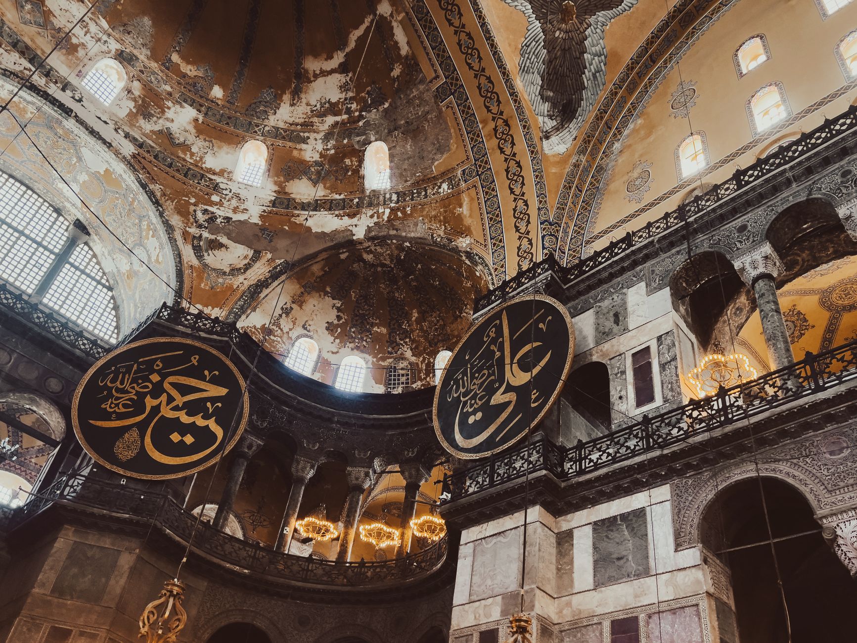 The upper gallery of Hagia Sophia, arches and a calligraphy roundel seen from the balcony level