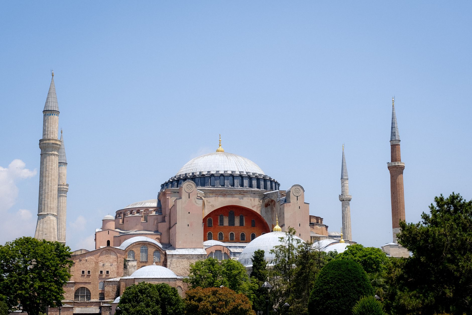 The exterior of Hagia Sophia in Istanbul, its layered domes and a minaret against the sky