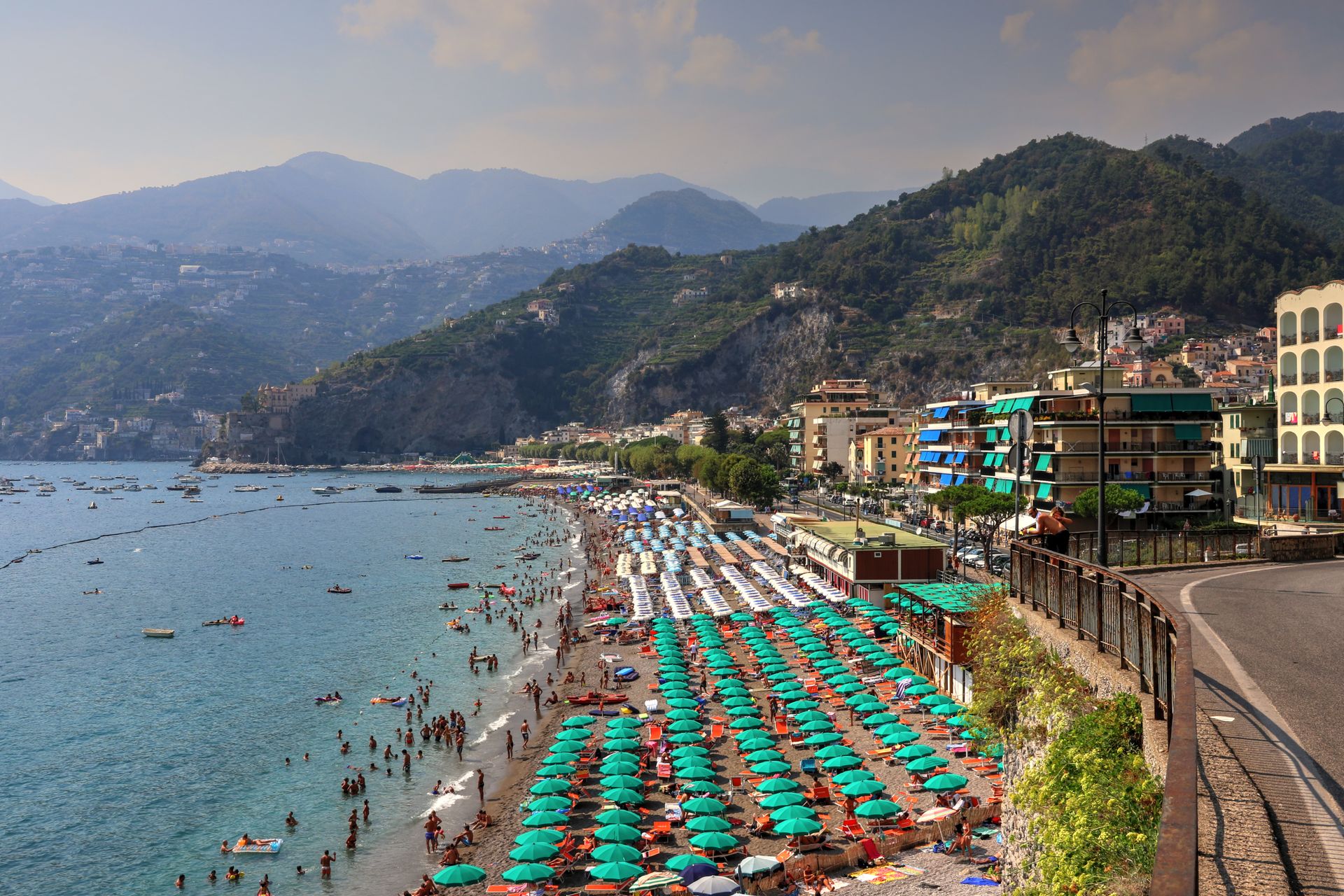 The beach at Maiori on the Amalfi coast, rows of green umbrellas along the water