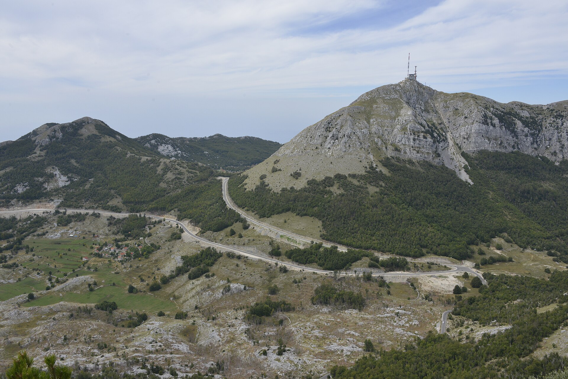 A rocky peak on the Lovćen massif crowned by a lattice telecommunications mast