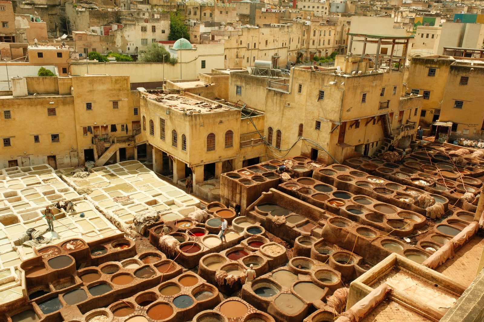 Stone dye vats of the Chouara Tannery below the rooftops of the Fez medina