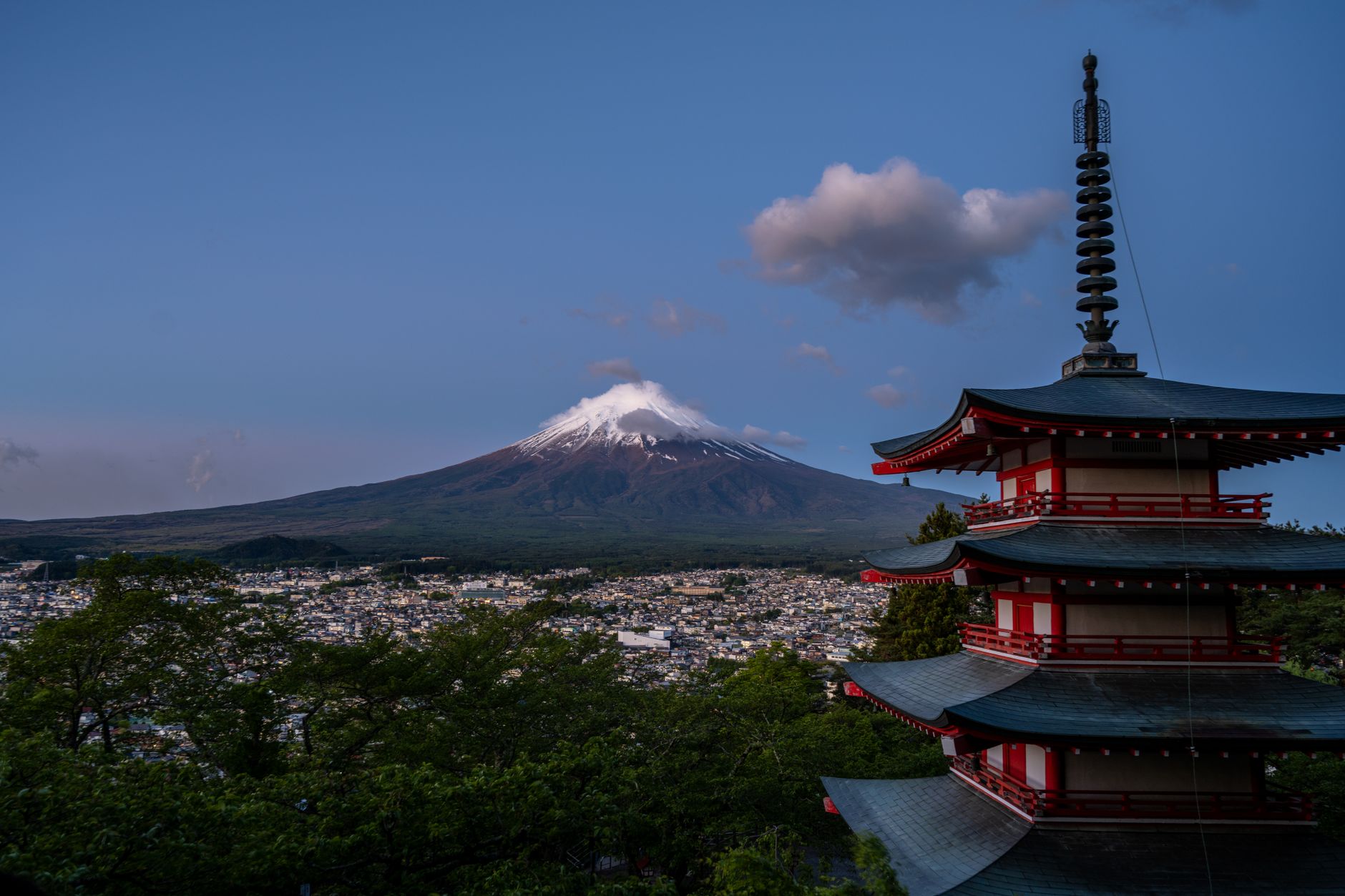 The five-storey Chureito Pagoda with Mount Fuji rising behind it at dusk