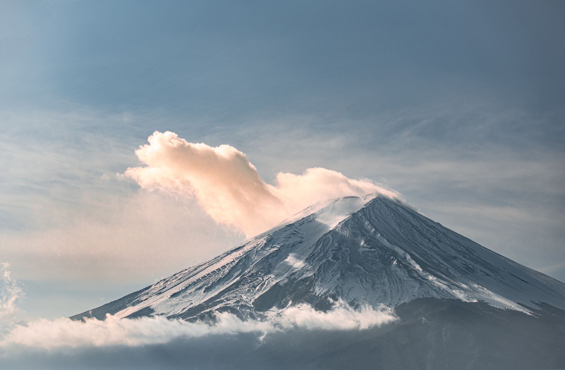 Mount Fuji catching first light with cloud banked against its flank