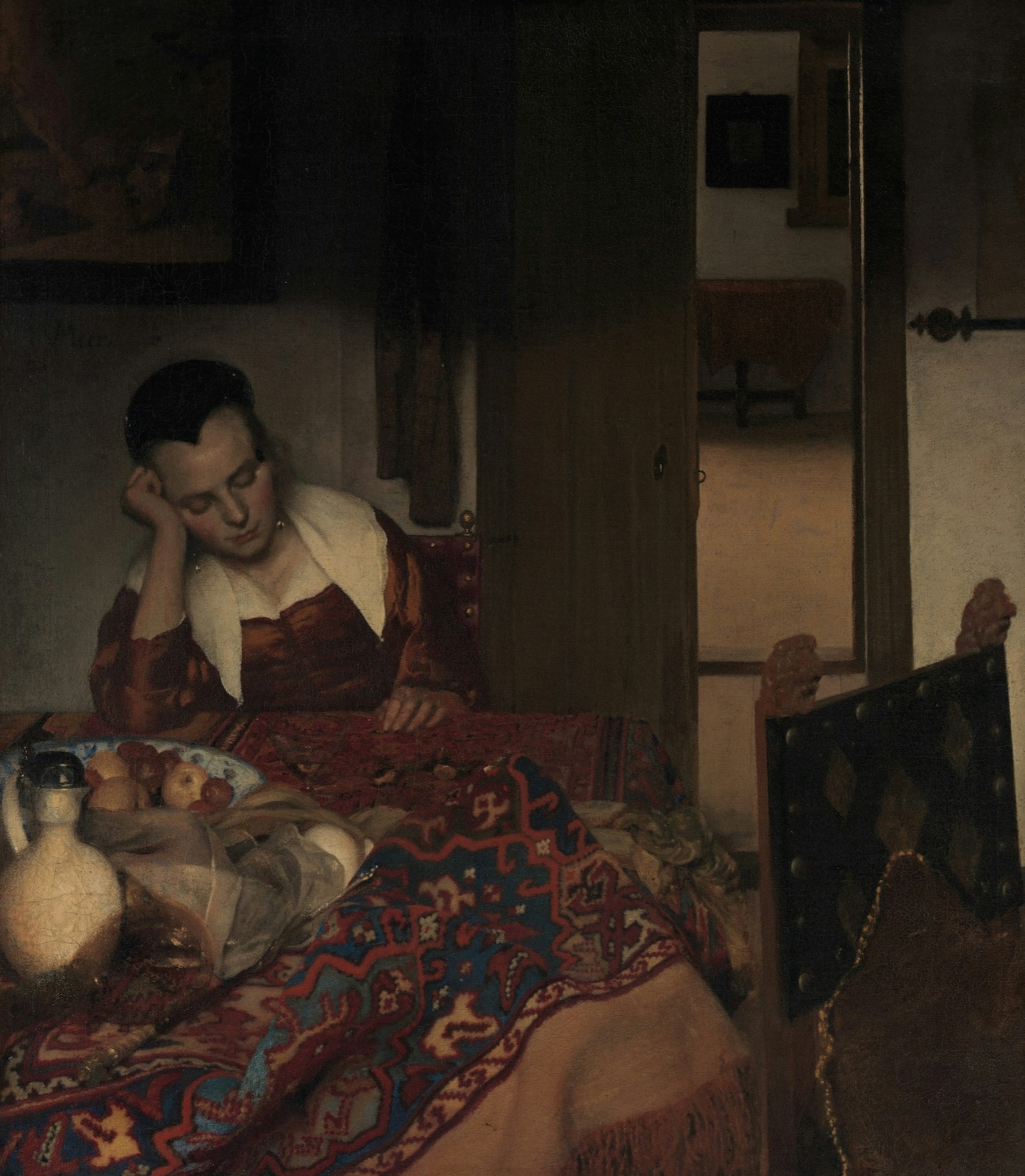 Vermeer's painting of a young woman asleep at a table covered with a rug