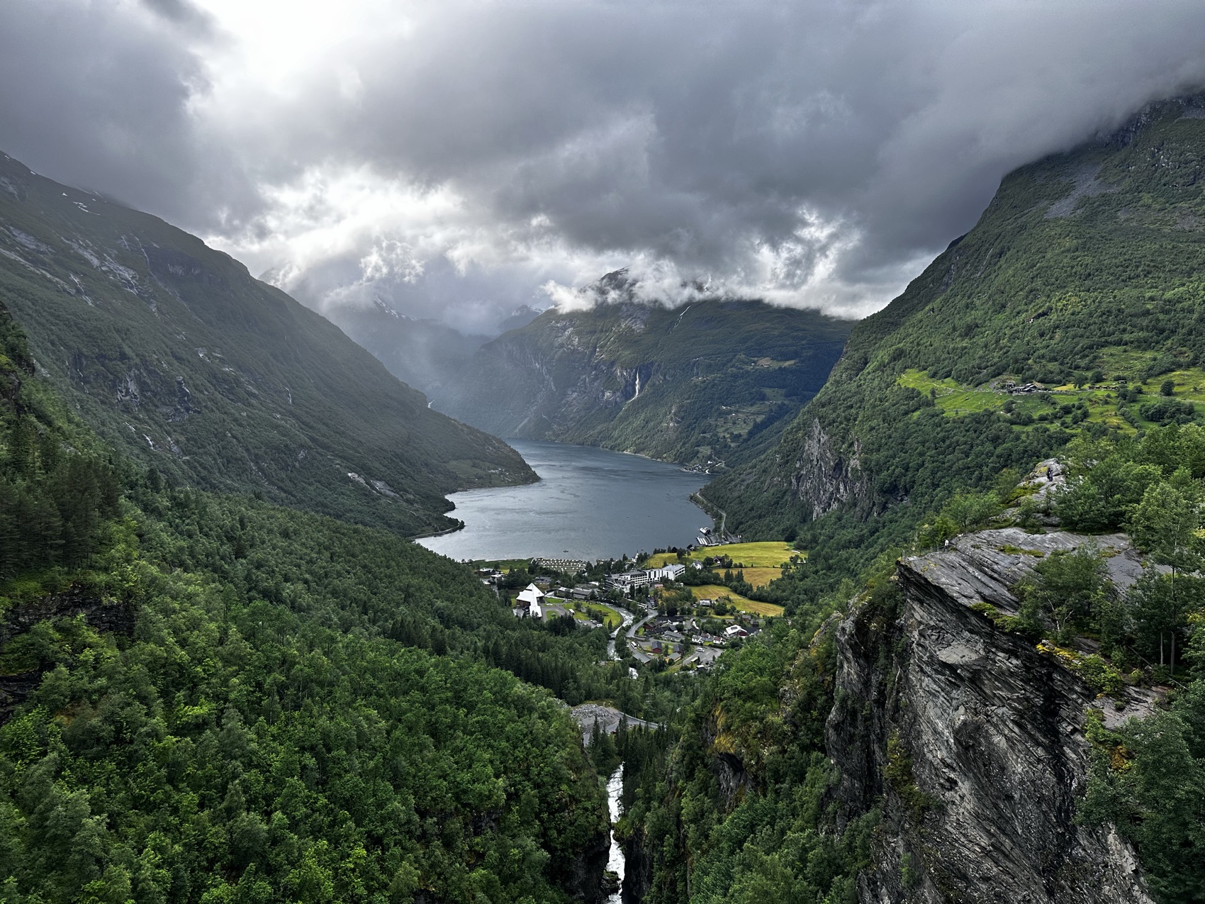 A view down the Geirangerfjord to the village far below, under heavy cloud