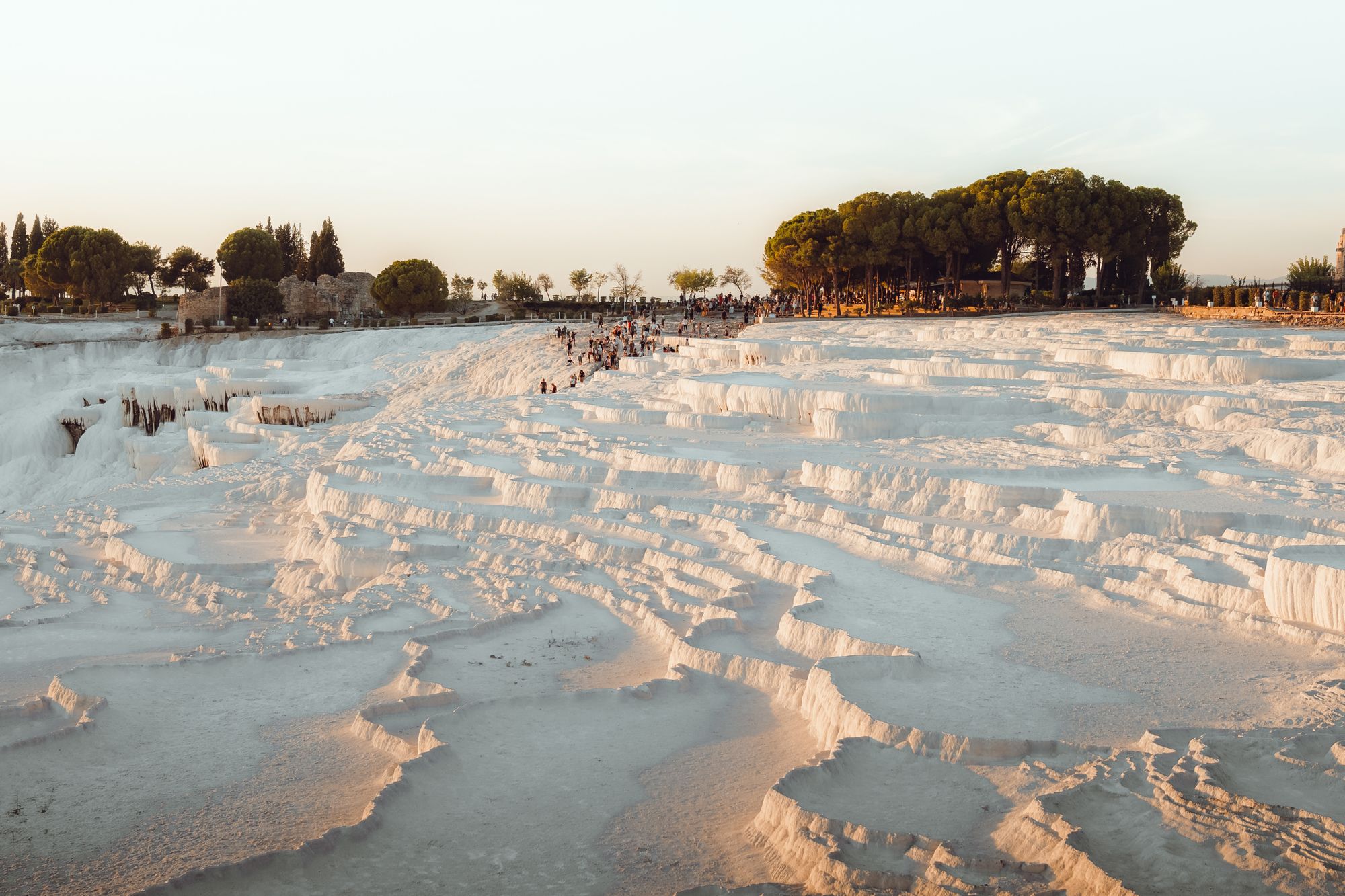 Pamukkale's white travertine terraces glowing in the late sun