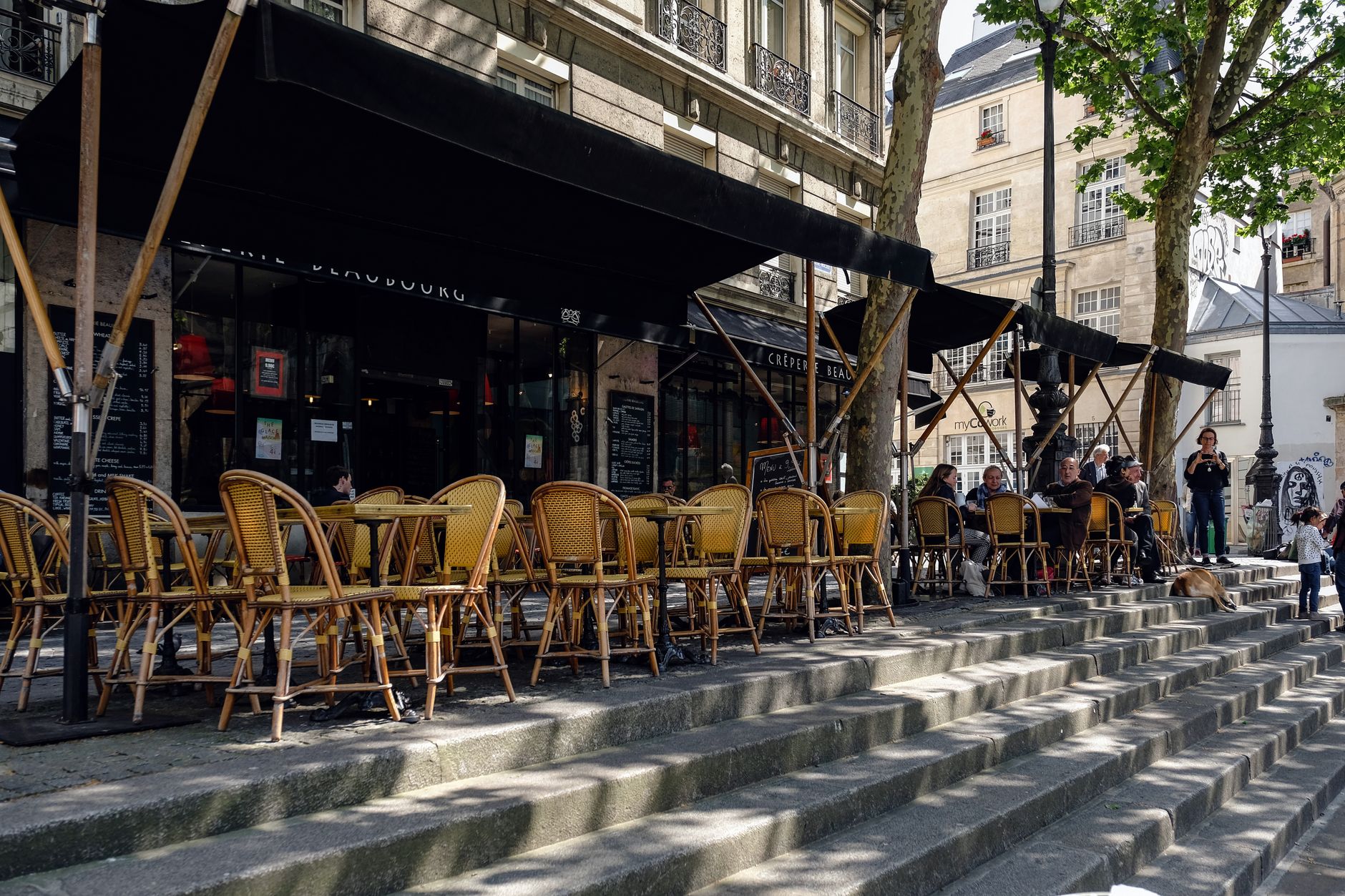 Wicker chairs on a cafe terrace in Saint-Germain