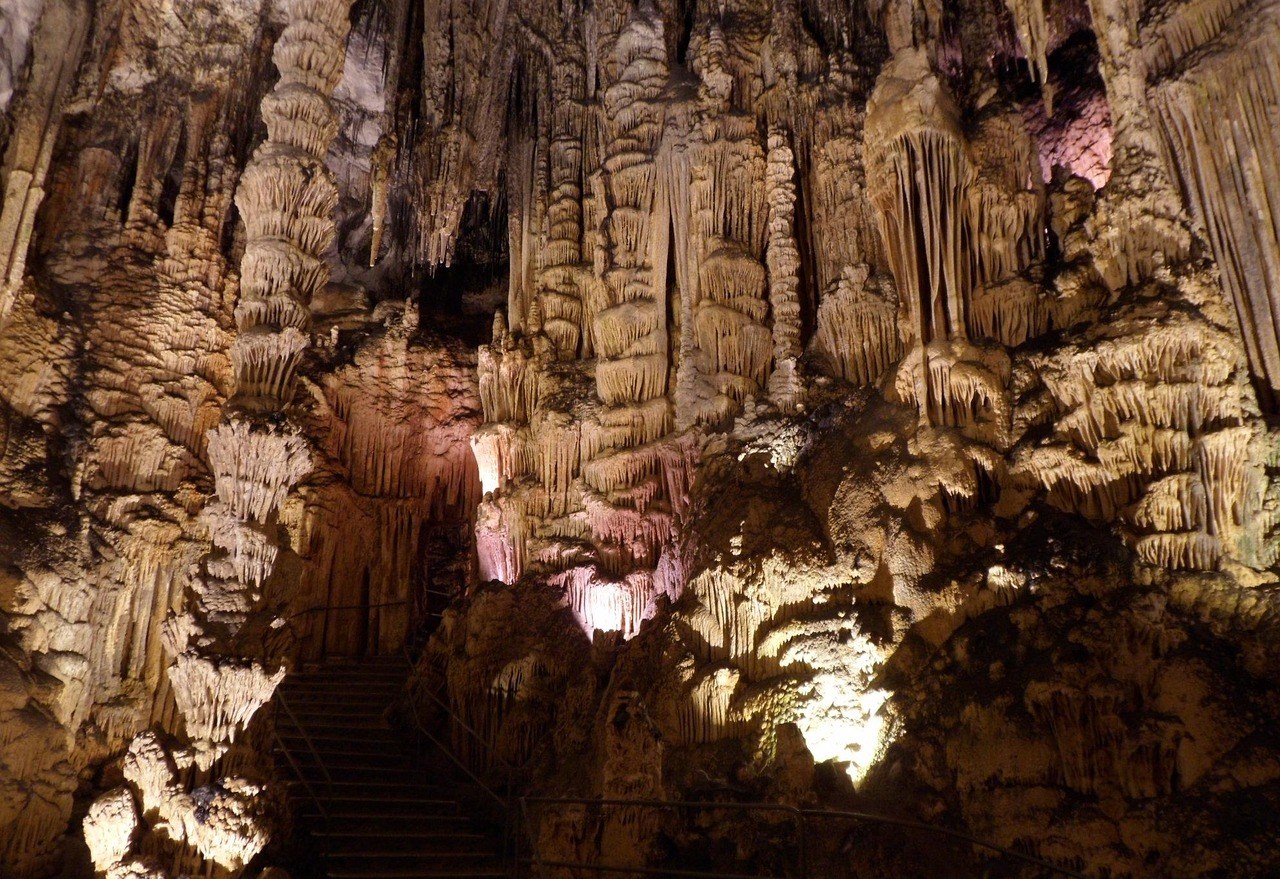 Dramatic lit stalactite and stalagmite formations in a Vietnamese cave
